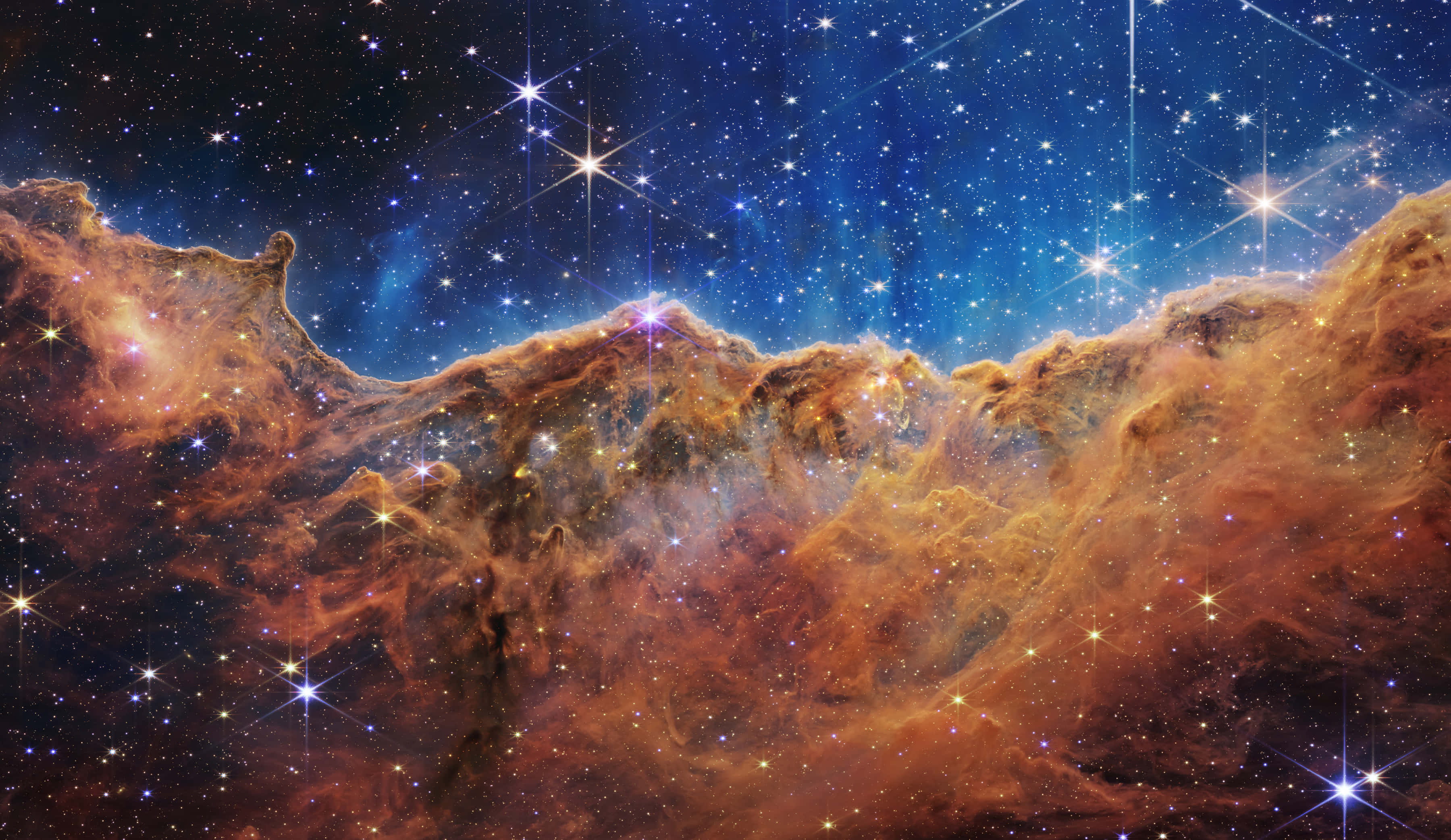 Carina Nebula, glowing orange clouds, sparkling stars, 2K Desktop Wallpaper