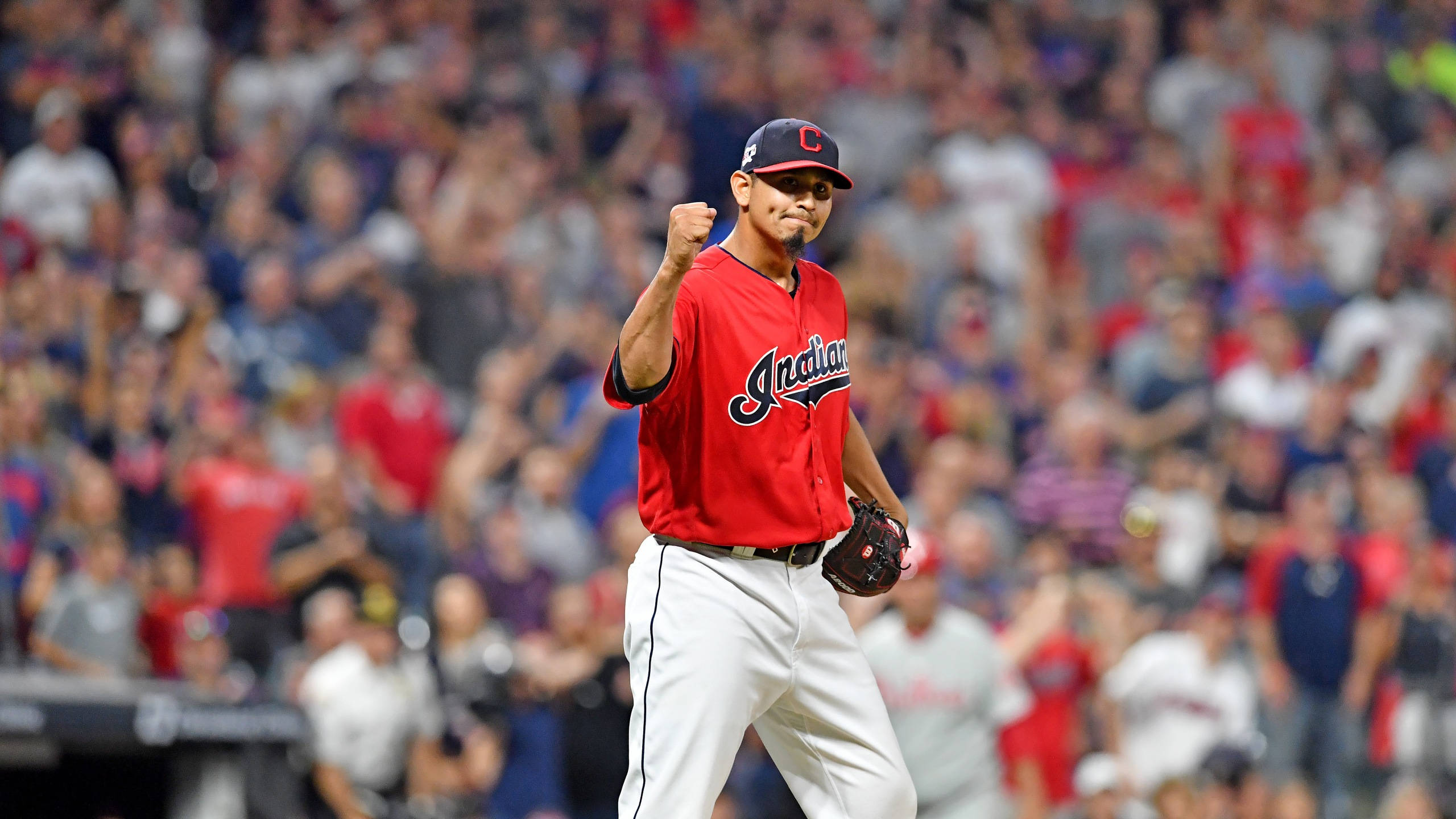 Carlos Carrasco, red Indians jersey, sunlit field, 2K Desktop Wallpaper