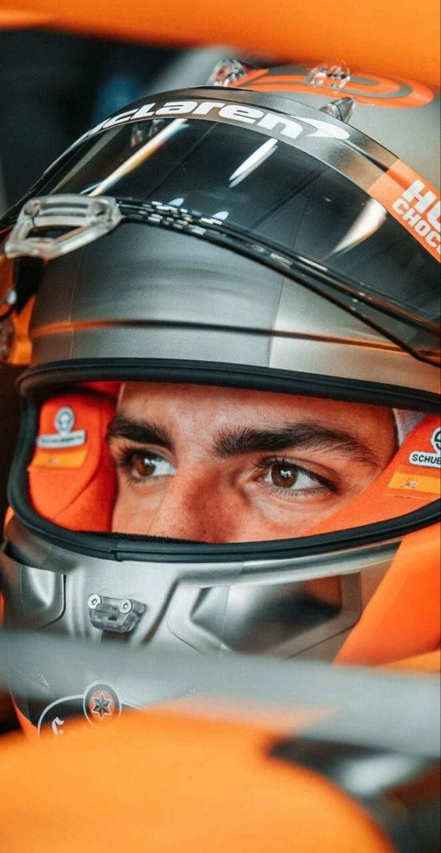 Carlos Sainz Jr, orange and silver McLaren helmet, sponsor logos, SD Phone Wallpaper