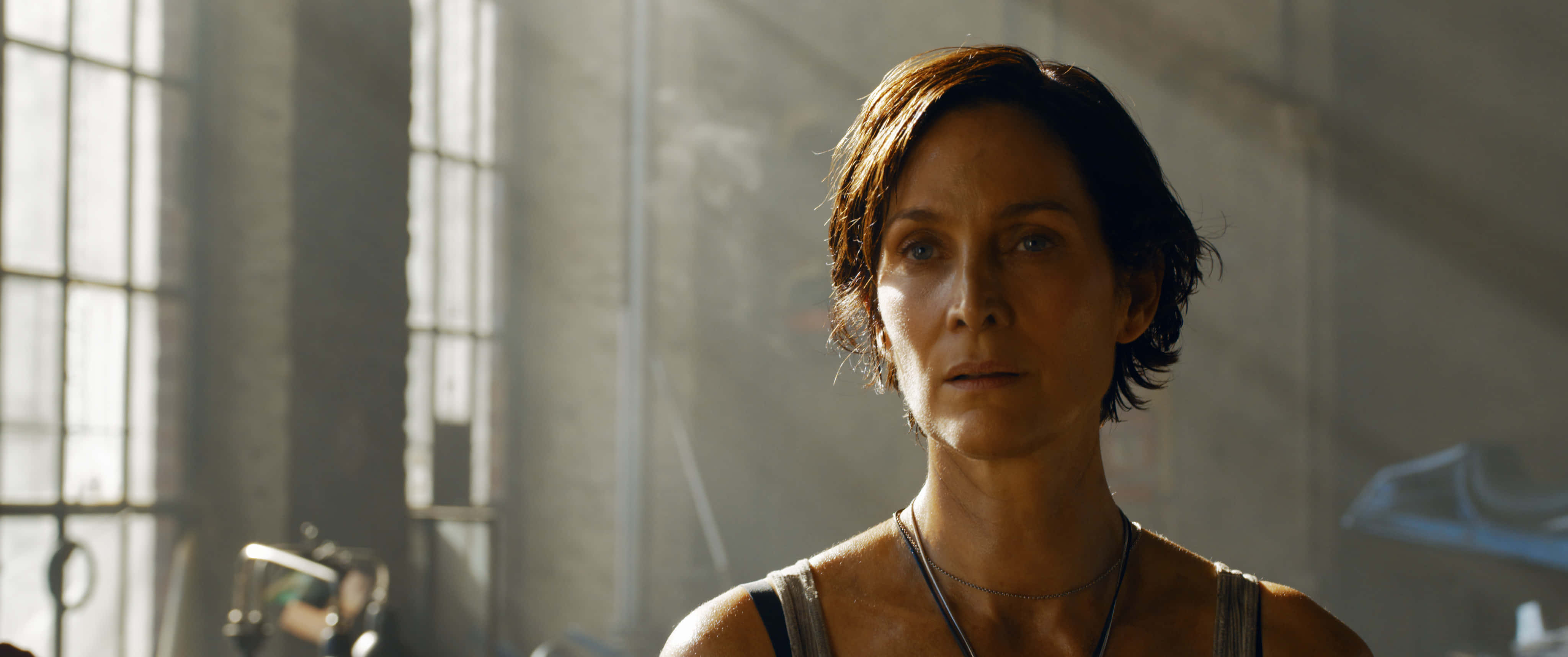 Carrie Anne Moss, short brown hair, sunlit industrial room, 4K Desktop Wallpaper