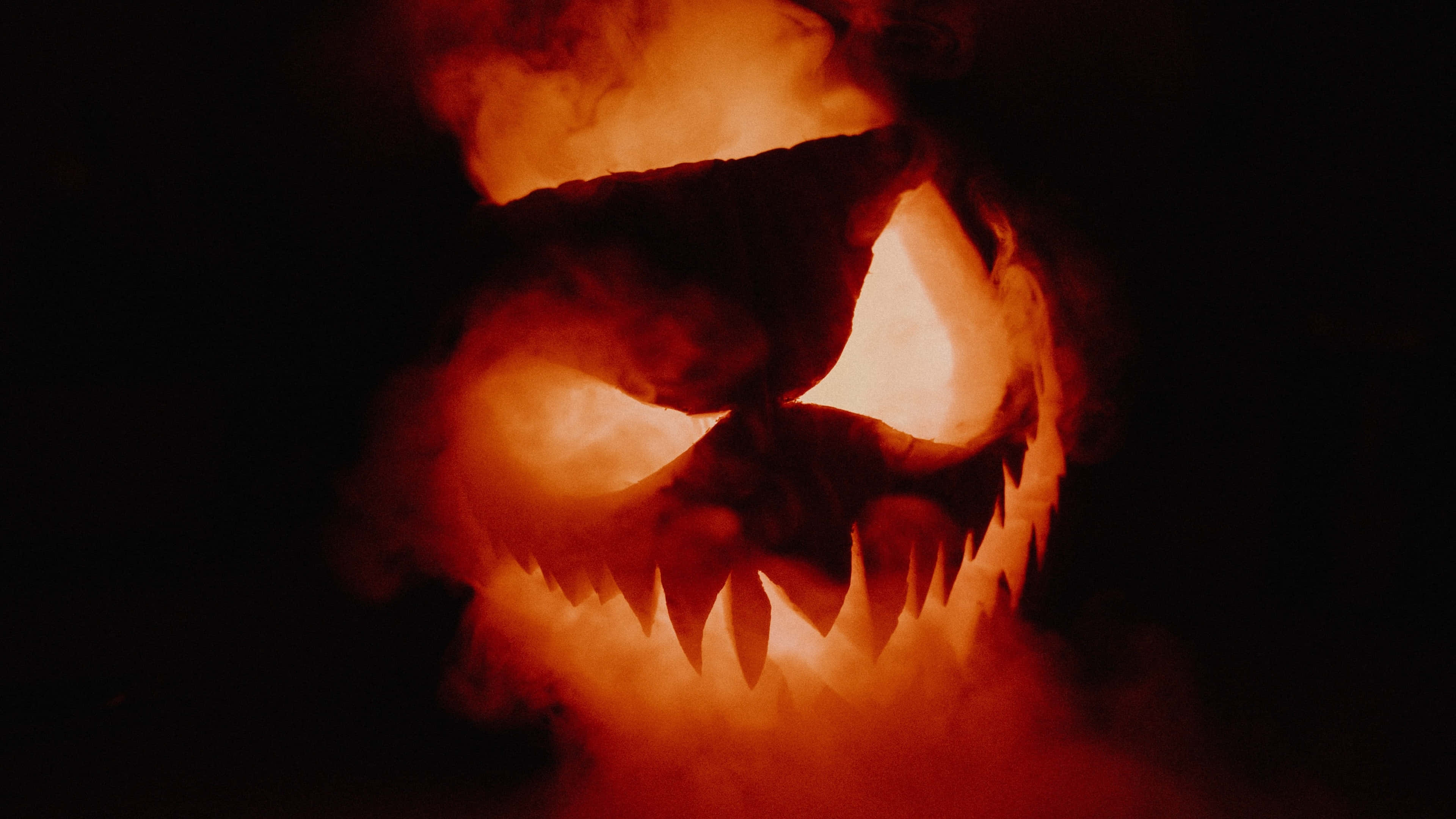 carved pumpkin, glowing eyes, jagged teeth, 4K Desktop Wallpaper