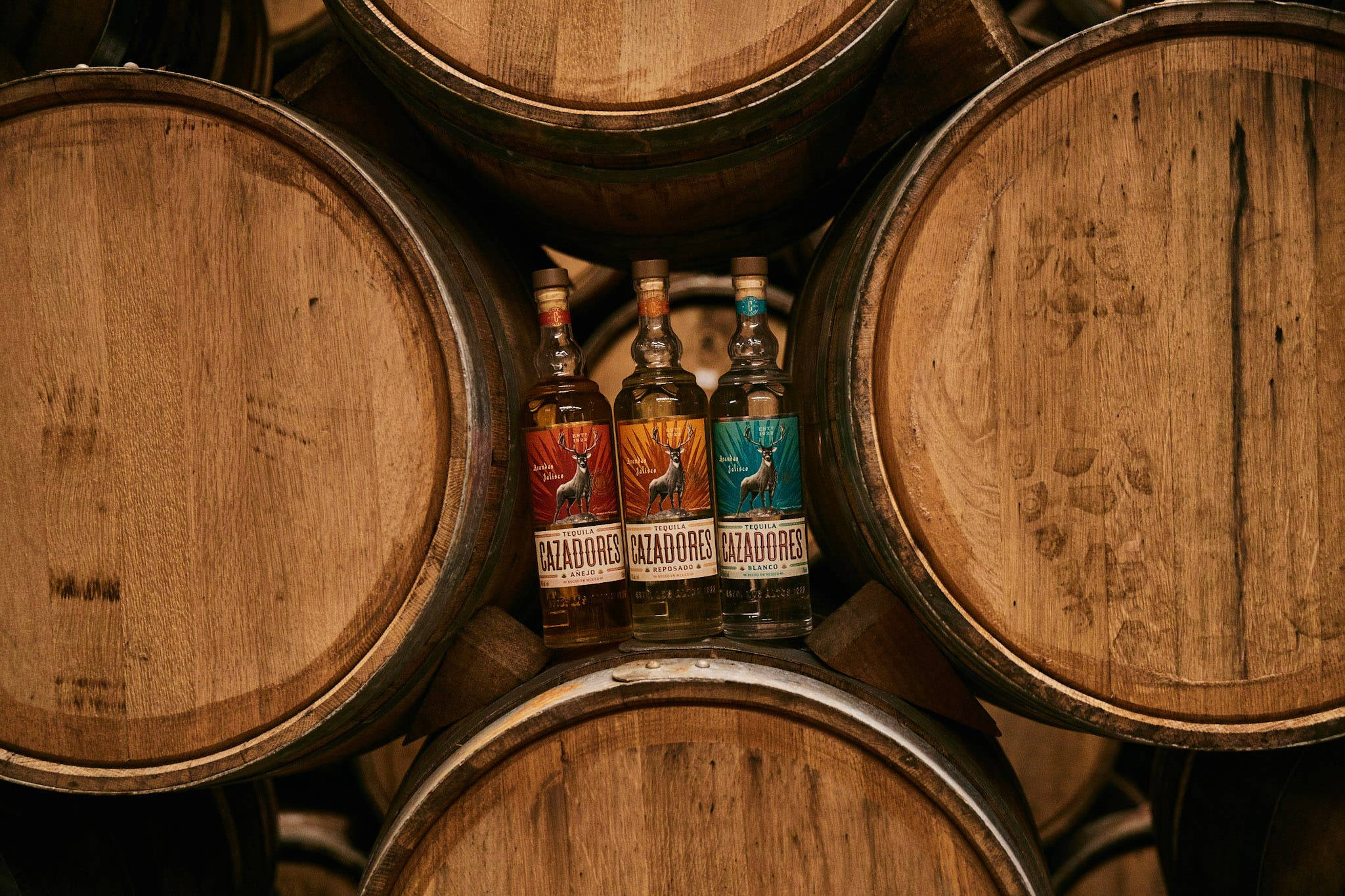 Cazadores Tequila, weathered wooden barrels, dimly lit distillery, Full HD Desktop Wallpaper