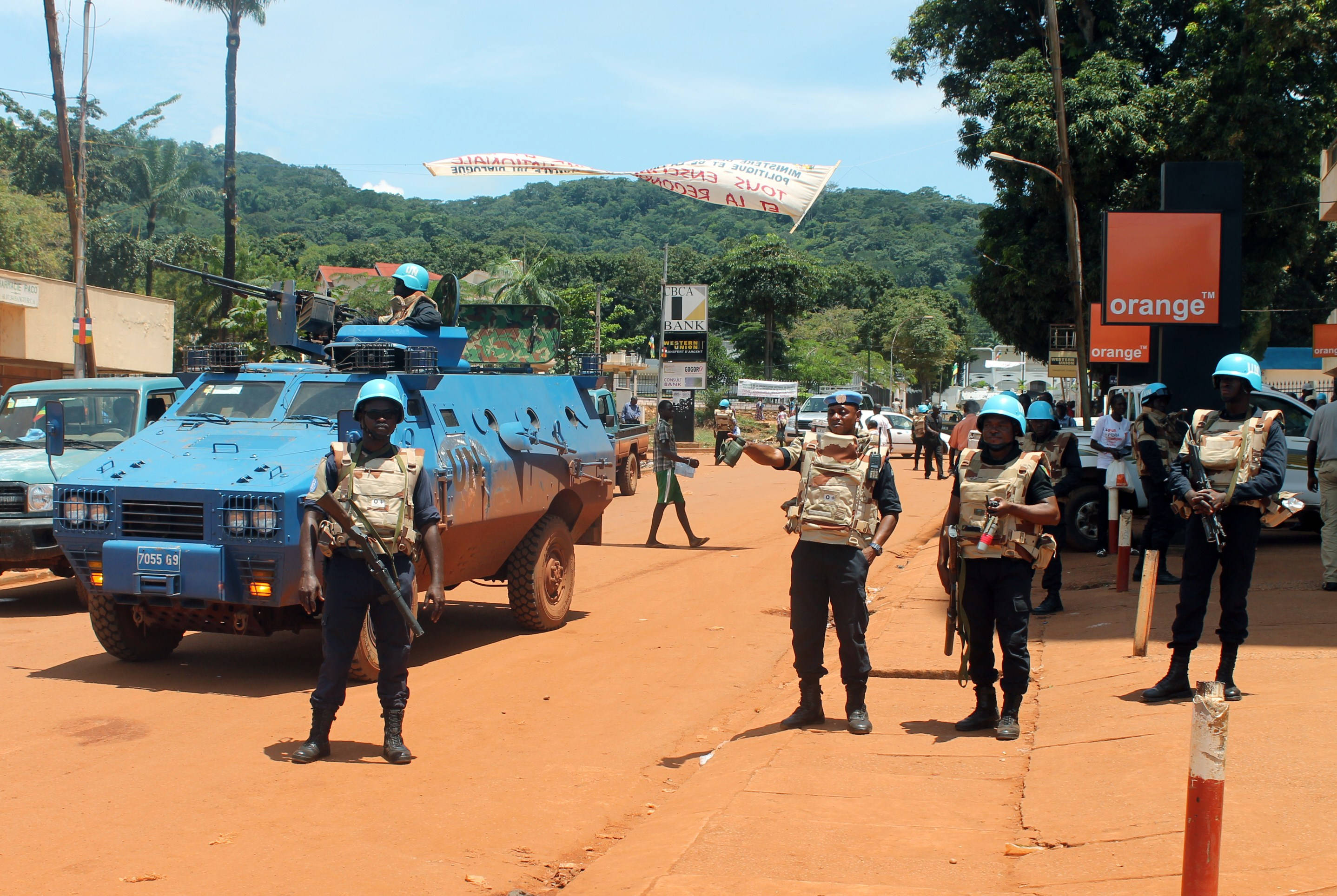 blue UN peacekeepers, blue armored vehicle, dusty orange road, 2K Desktop Wallpaper