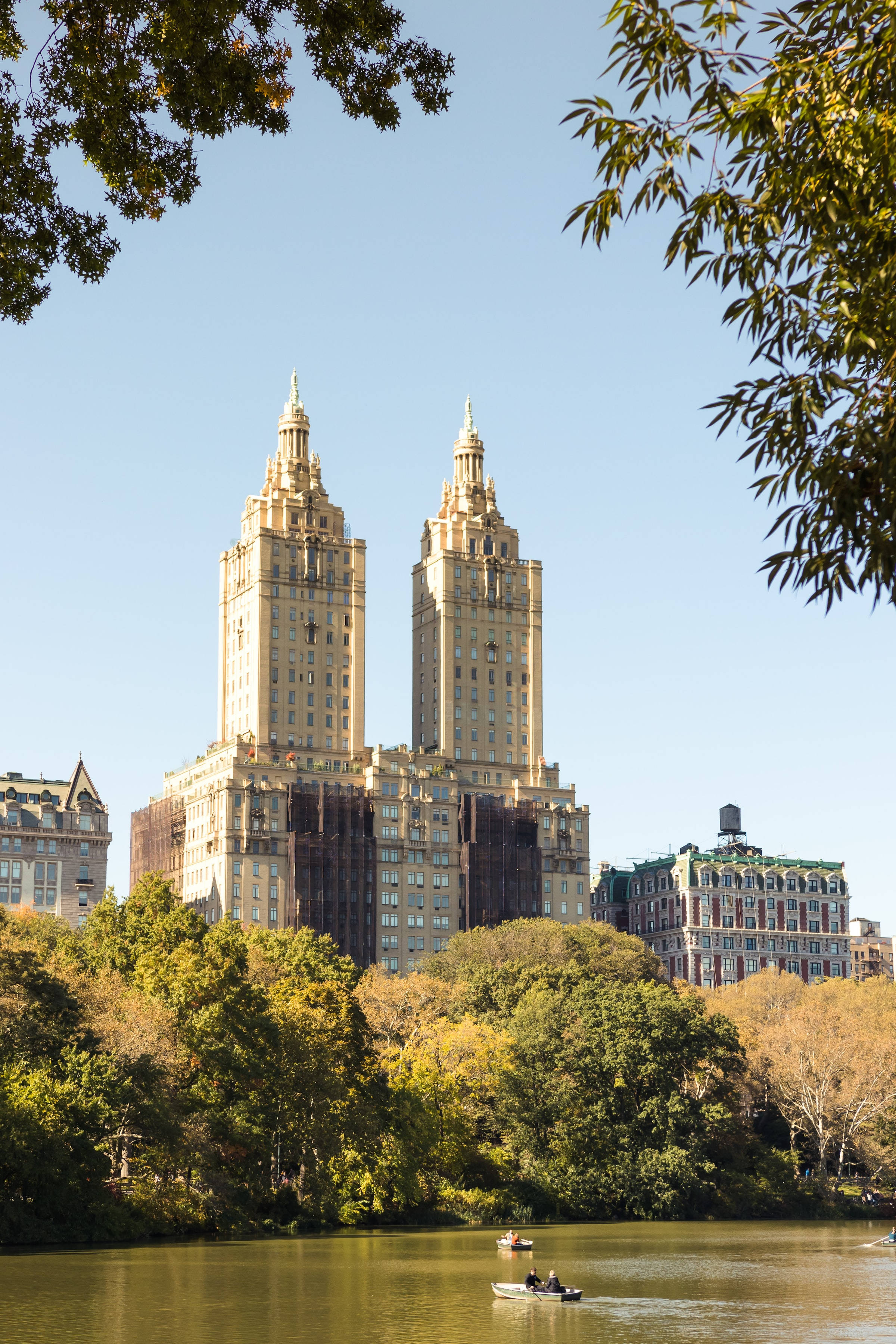 Art Deco skyscrapers, Central Park lake, autumn trees, 2K Phone Wallpaper