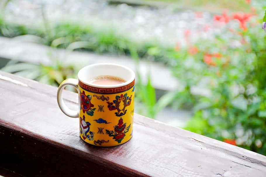 Chai, vibrant yellow mug, intricate red blue and green patterns, SD Desktop Wallpaper