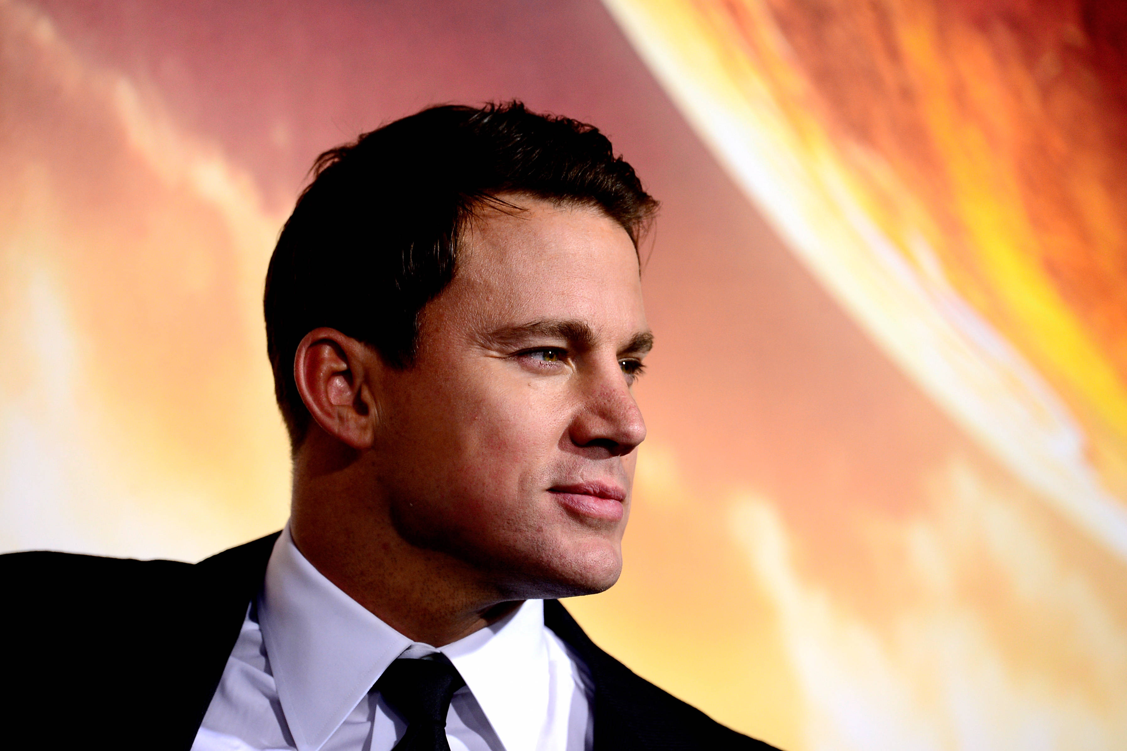 Channing Tatum, black suit and tie, fiery orange and yellow abstract backdrop, 2K Desktop Wallpaper