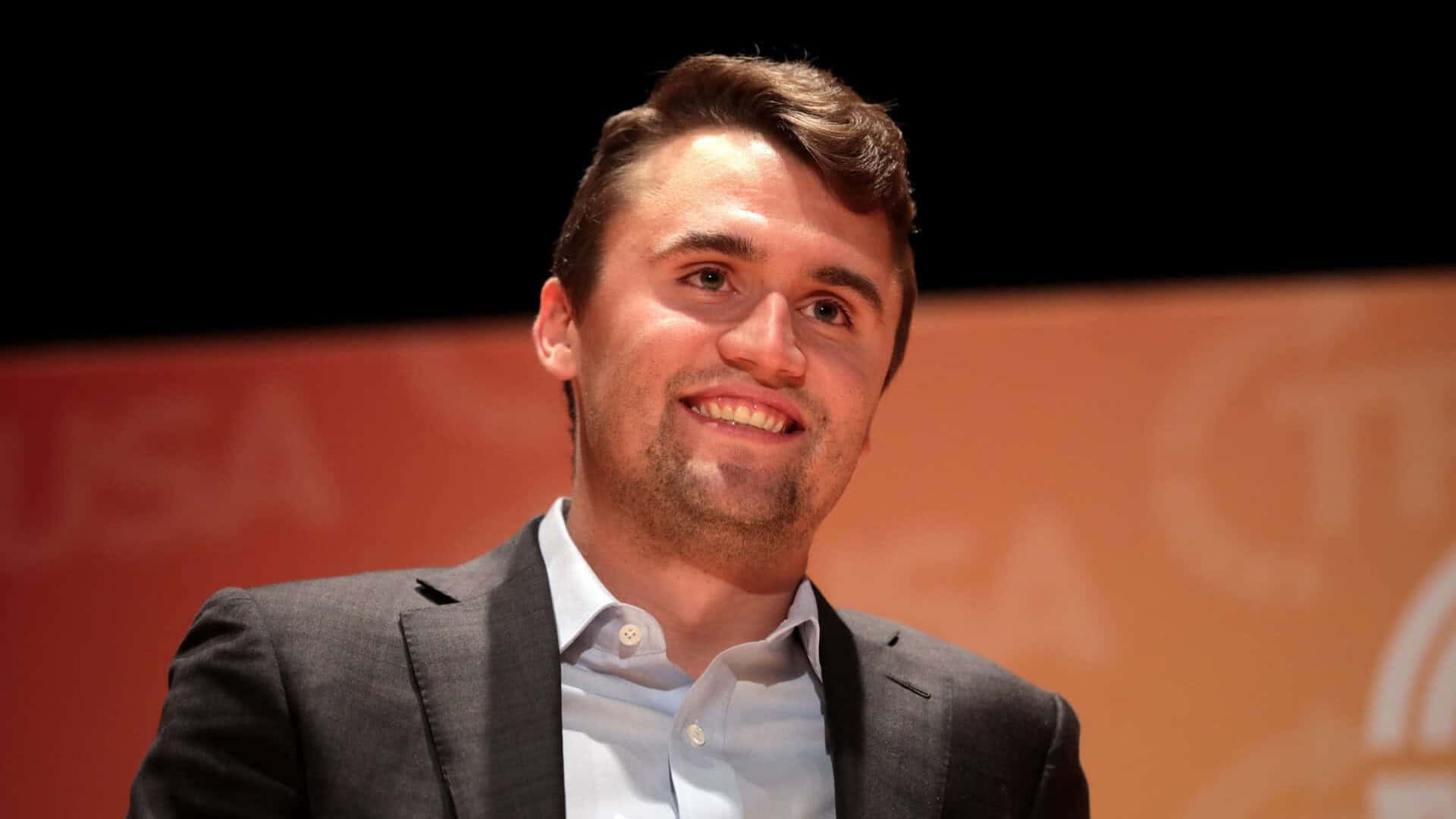 Charlie Kirk, gray suit jacket, light blue button-down shirt, Full HD Desktop Wallpaper