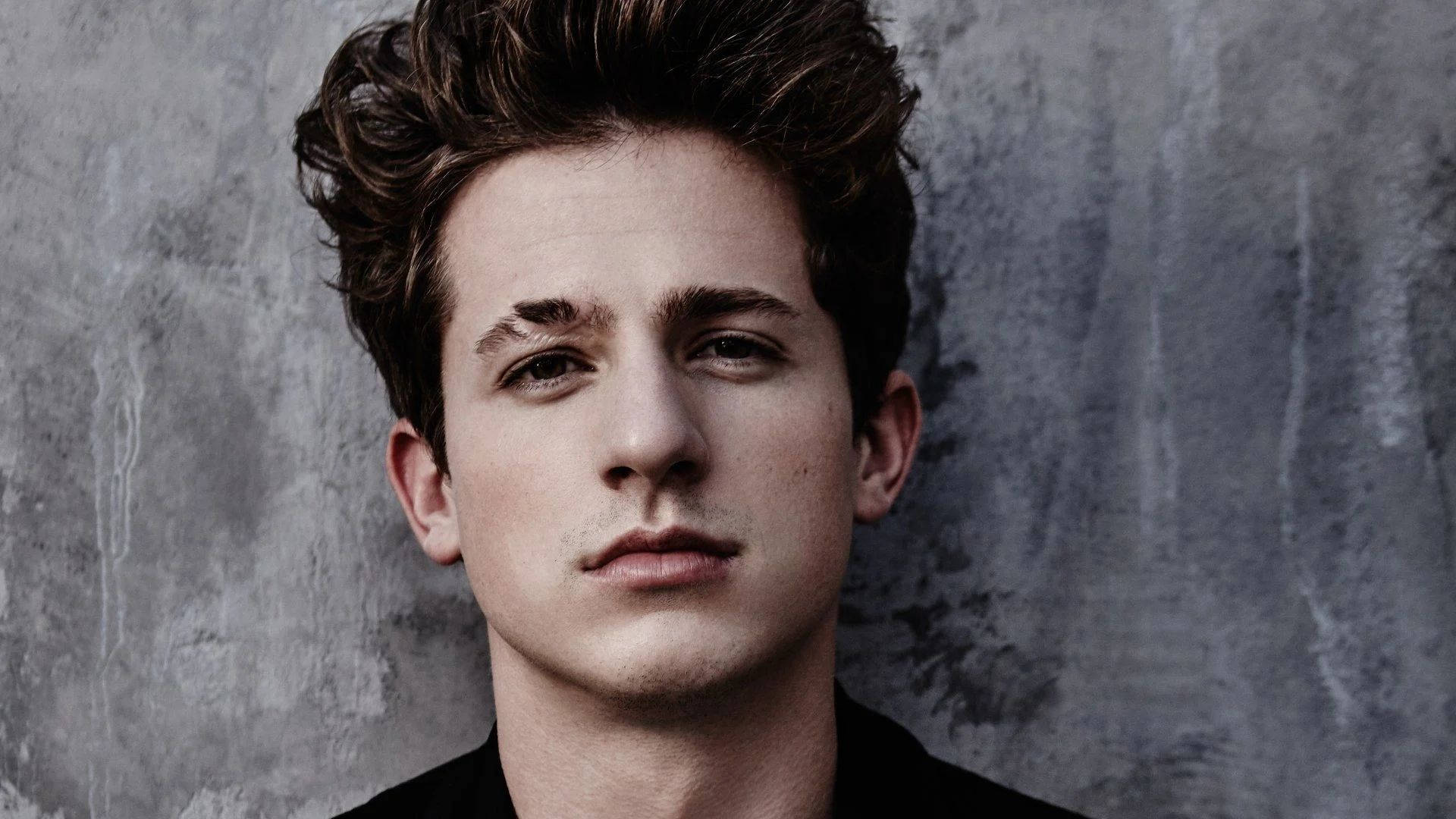 Charlie Puth, tousled brown hair, textured gray concrete wall, Full HD Desktop Wallpaper