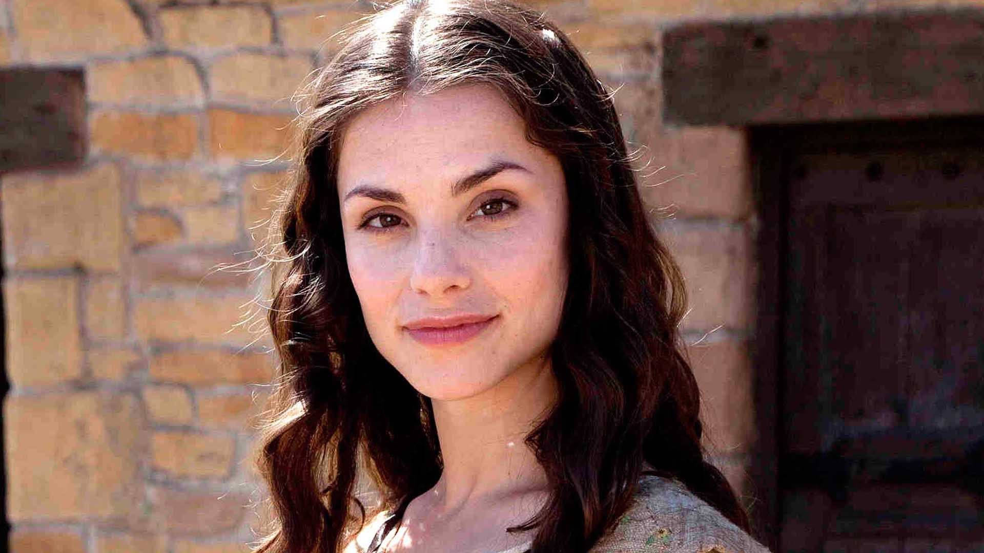 Charlotte Riley, wavy brown hair, sunlit stone wall, Full HD Desktop Wallpaper