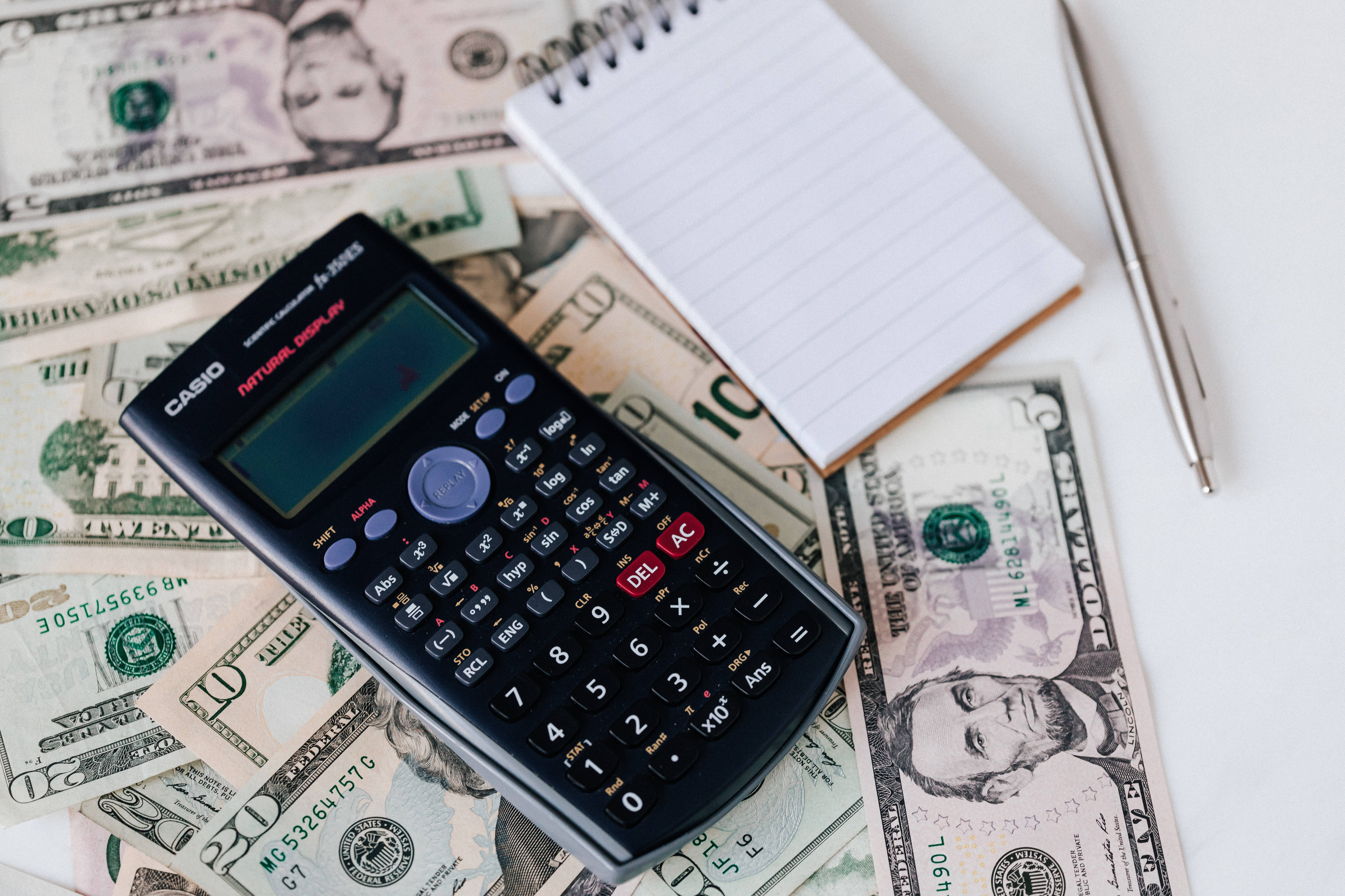 Casio calculator, US dollar bills, spiral notebook, 5K Desktop Wallpaper