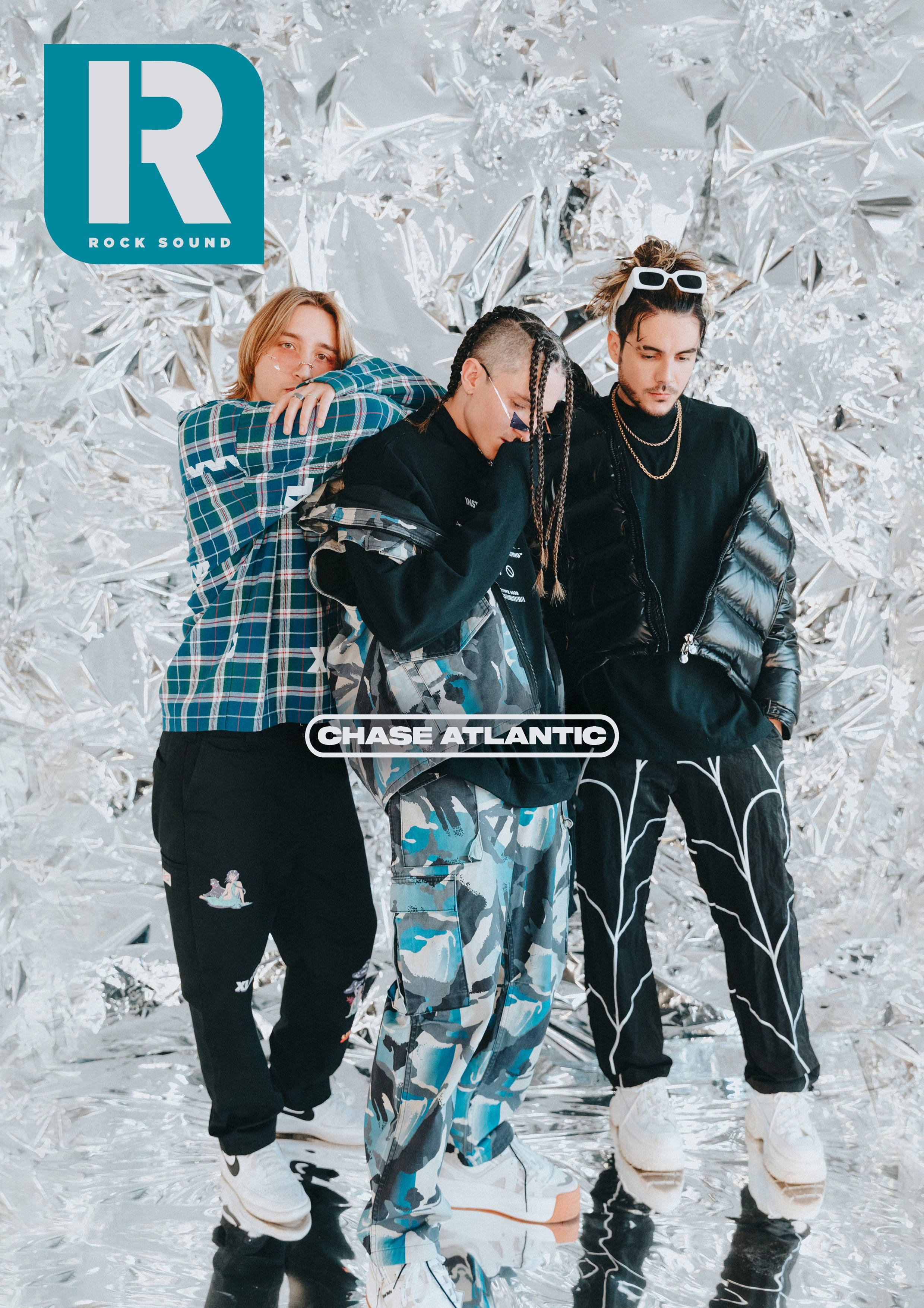 Chase Atlantic, shimmering silver foil backdrop, reflective floor, 2K Phone Wallpaper