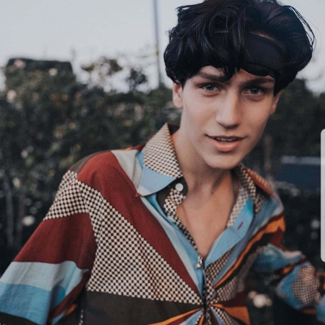 Chase Hudson, dark curly hair, colorful geometric-patterned shirt, SD Desktop Wallpaper