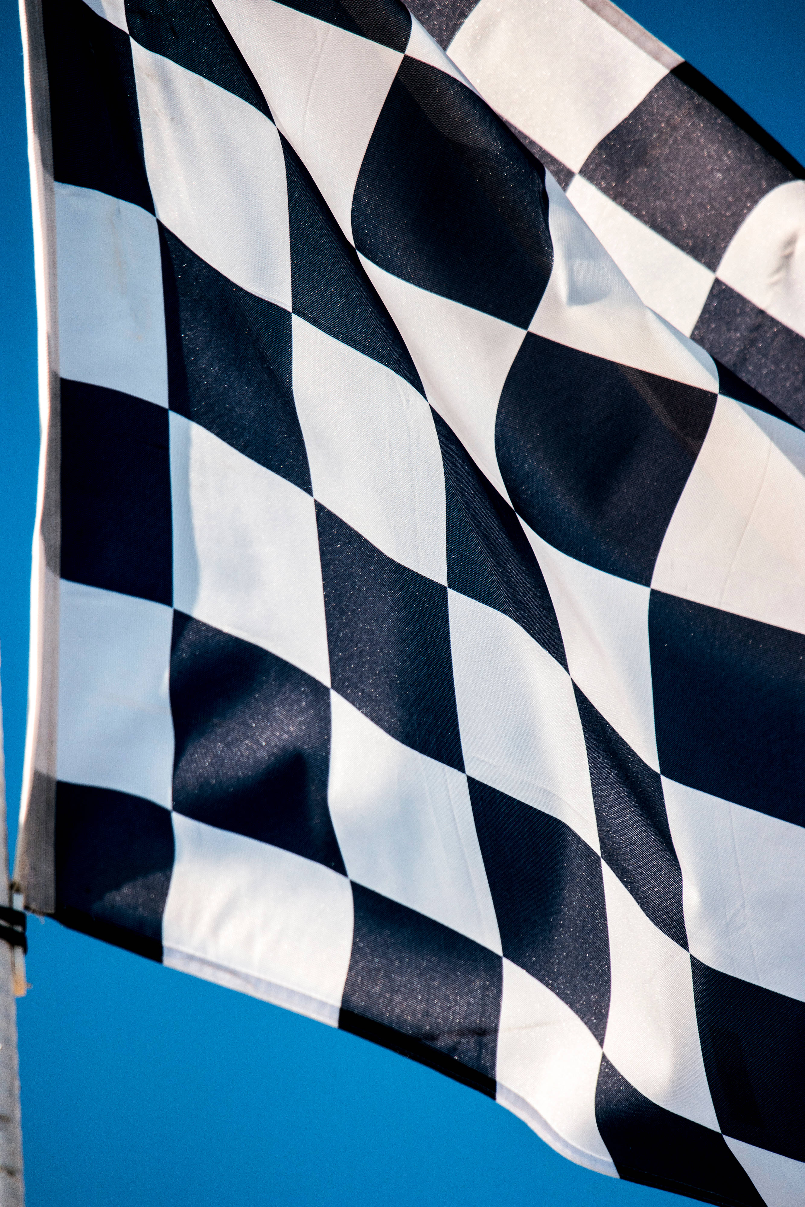 checkered race flag, black and white checkered, clear blue sky, 4K Phone Wallpaper