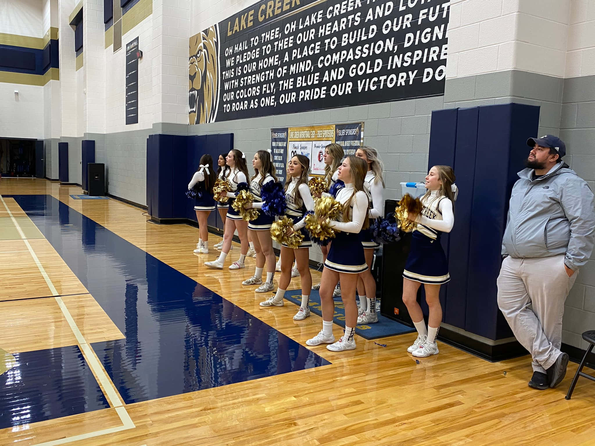 blue and gold uniforms, polished wooden gym floor, large school spirit banner, Full HD Desktop Wallpaper