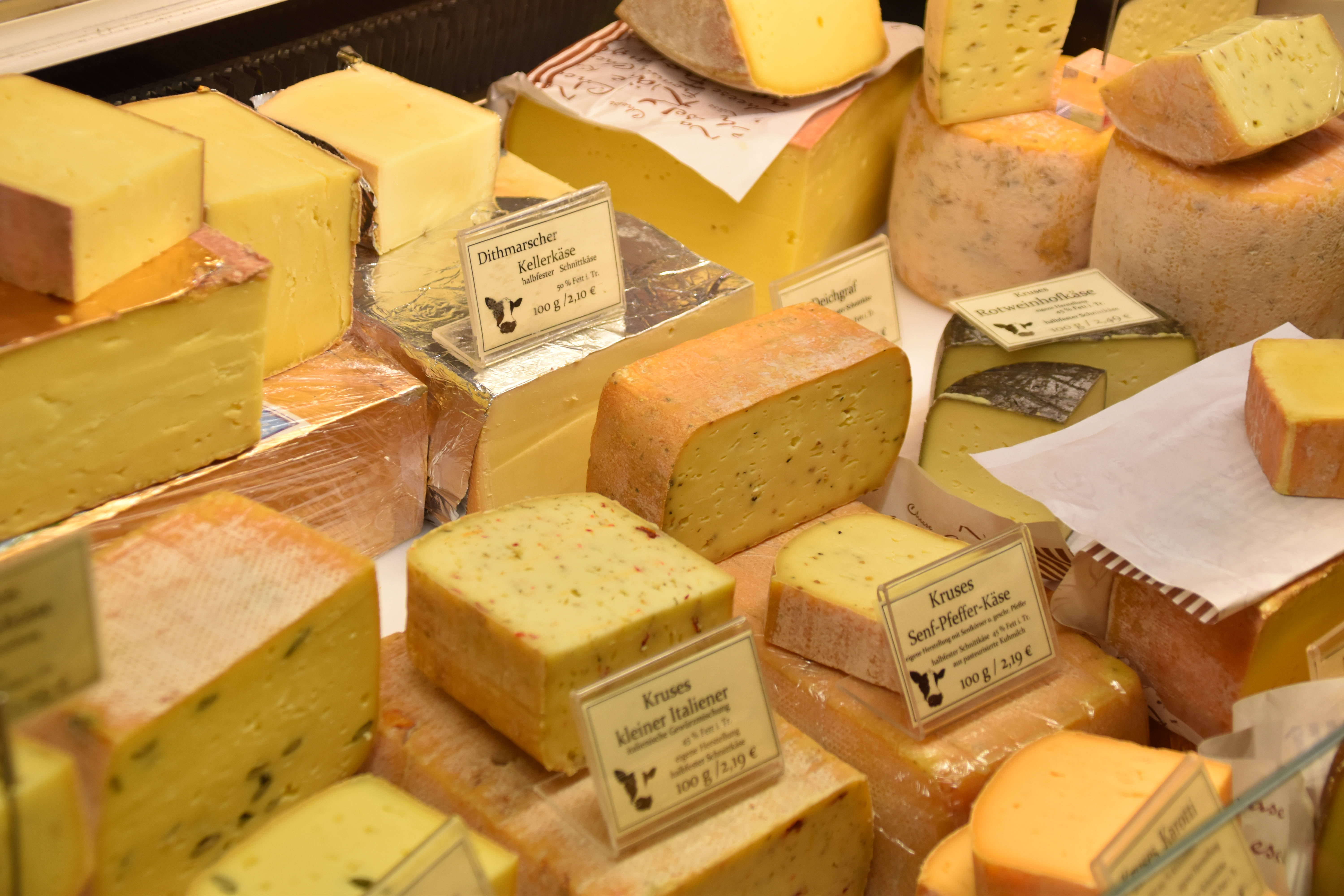 assorted artisanal cheeses, market stall, labels, 5K Desktop Wallpaper