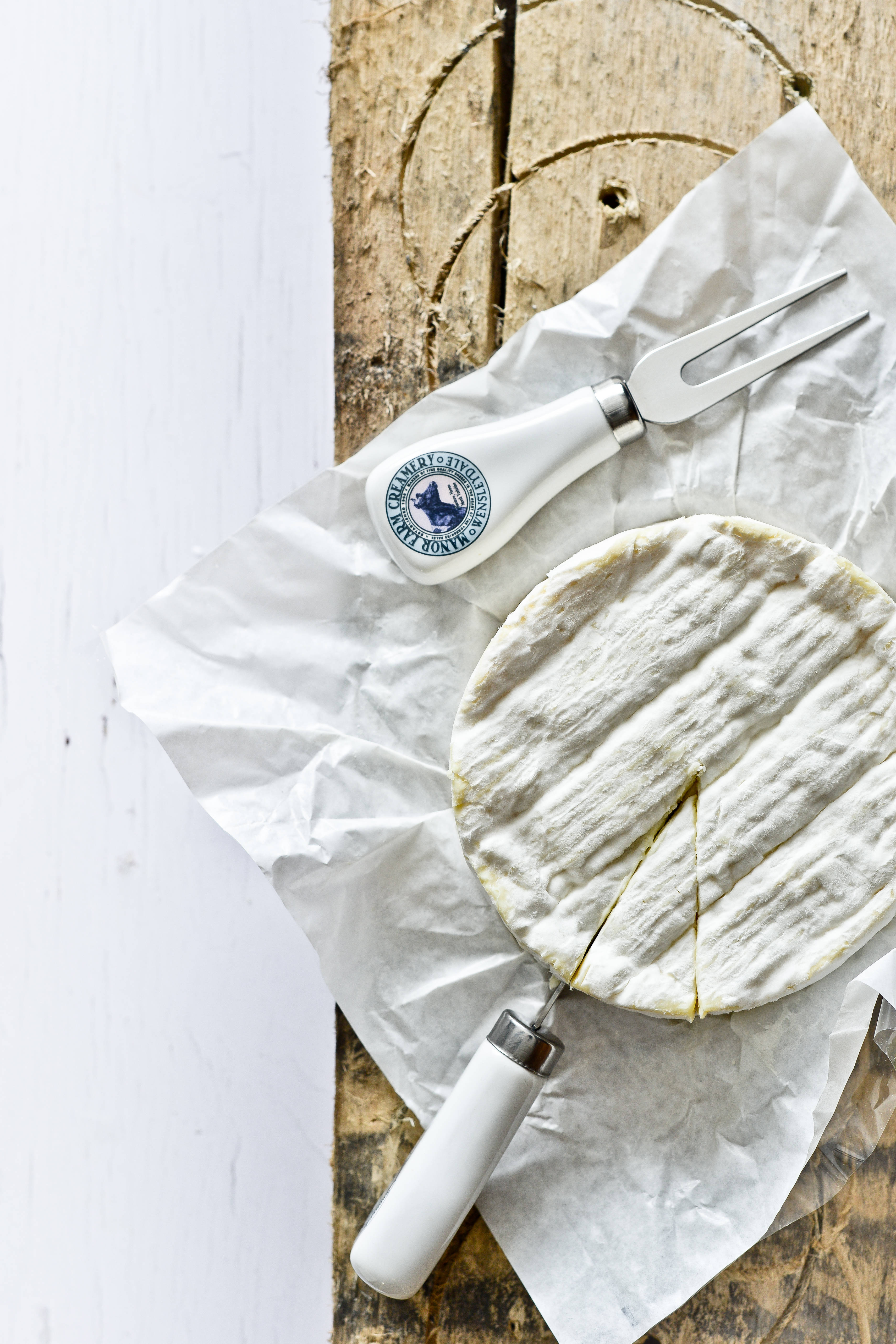 round wheel of creamy white cheese, slice cut, crumpled parchment, 5K Phone Wallpaper