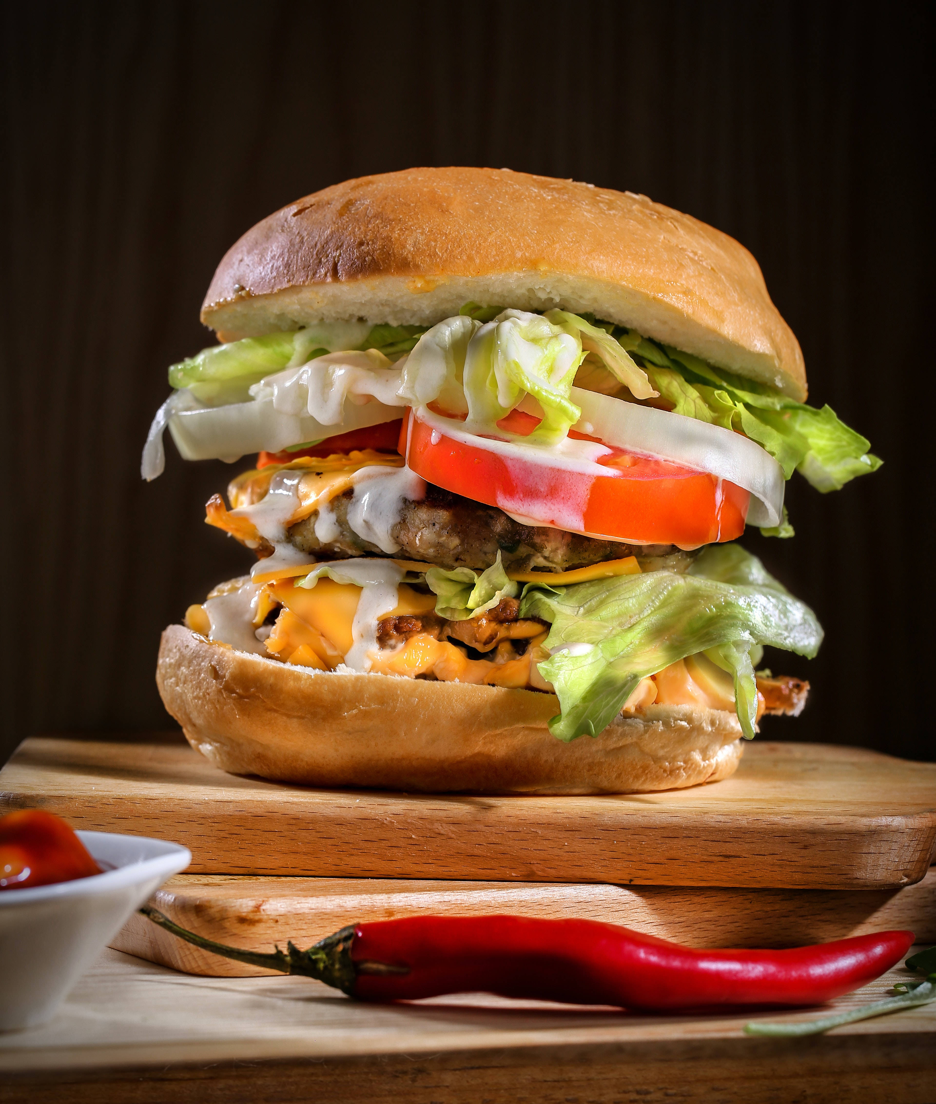 cheeseburger, wooden board, red chili pepper, 4K Phone Wallpaper