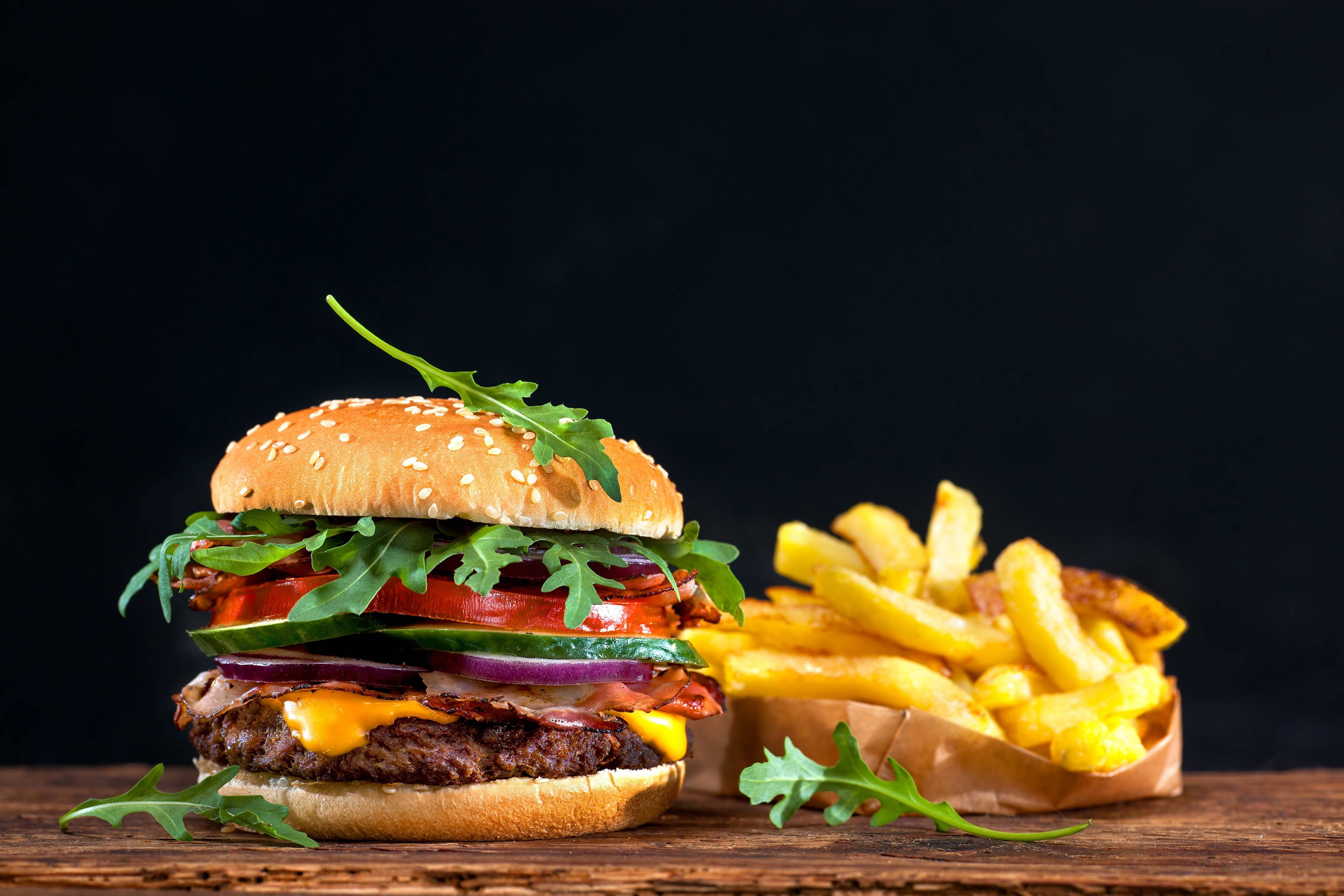 Veggie Cheeseburger, golden fries, rustic wooden table, 4K Desktop Wallpaper
