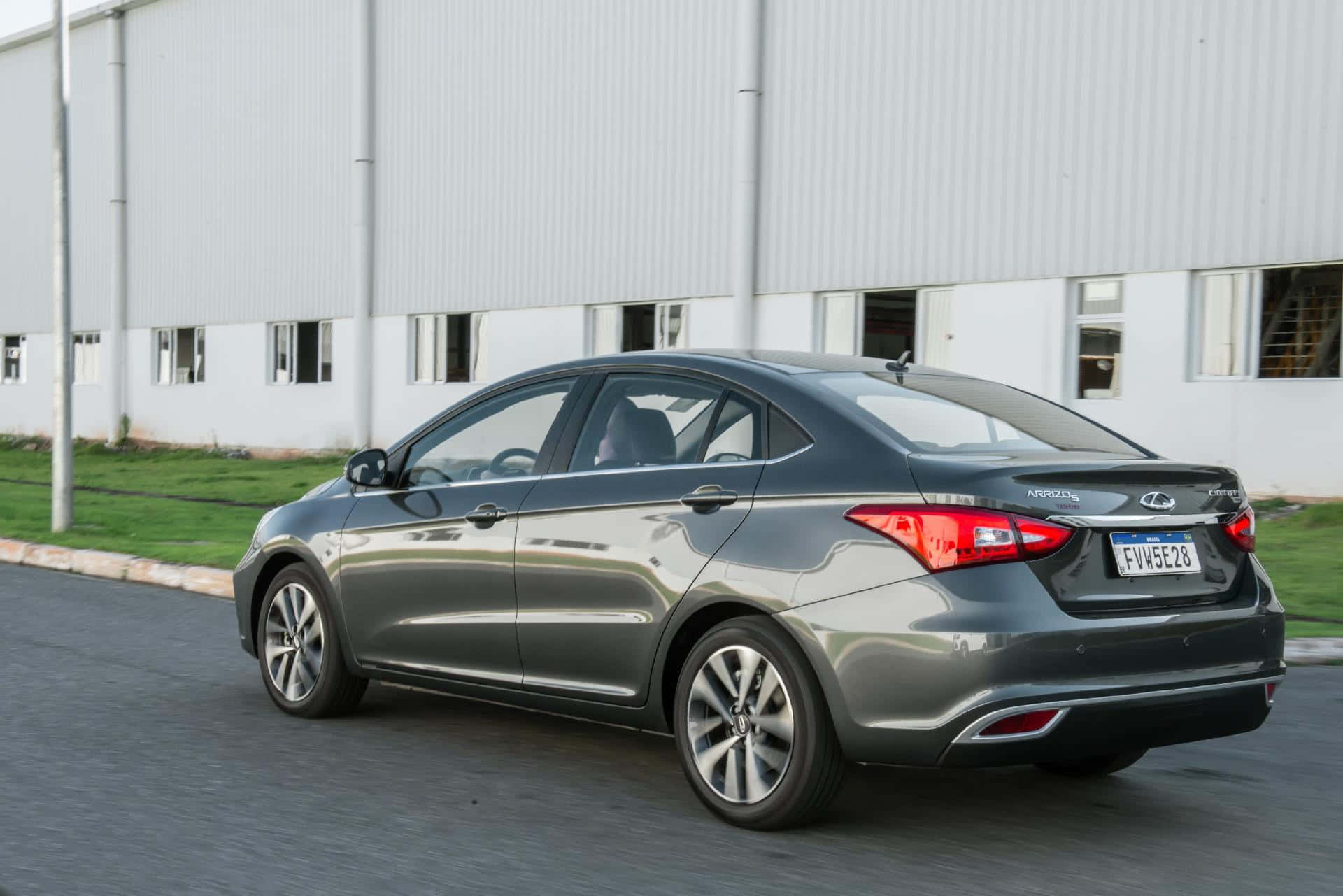 Chery Arrizo 5, sleek gray sedan, modern industrial building, Full HD Desktop Wallpaper