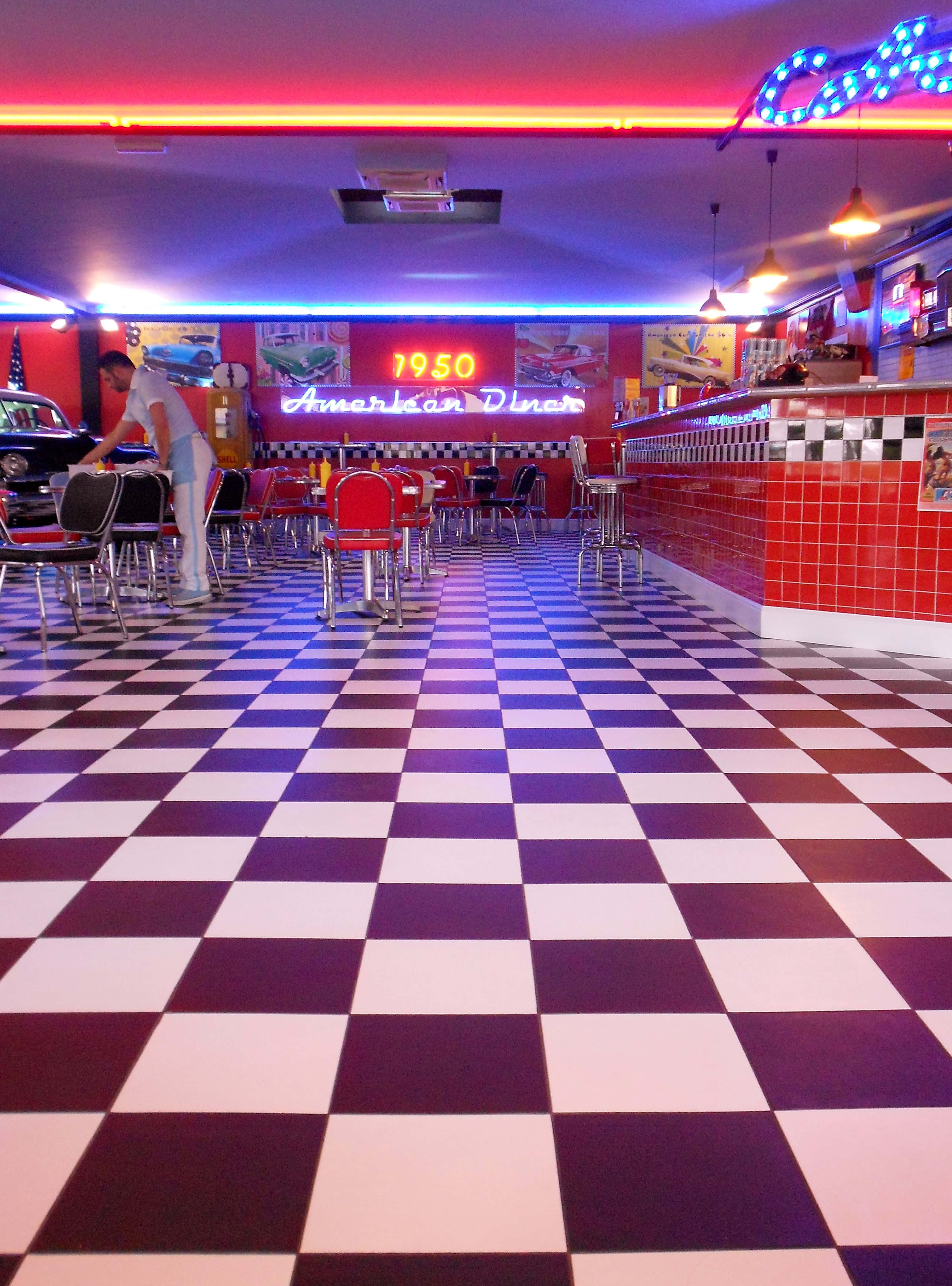 1950s American diner, checkered floor, neon signs, 4K Phone Wallpaper