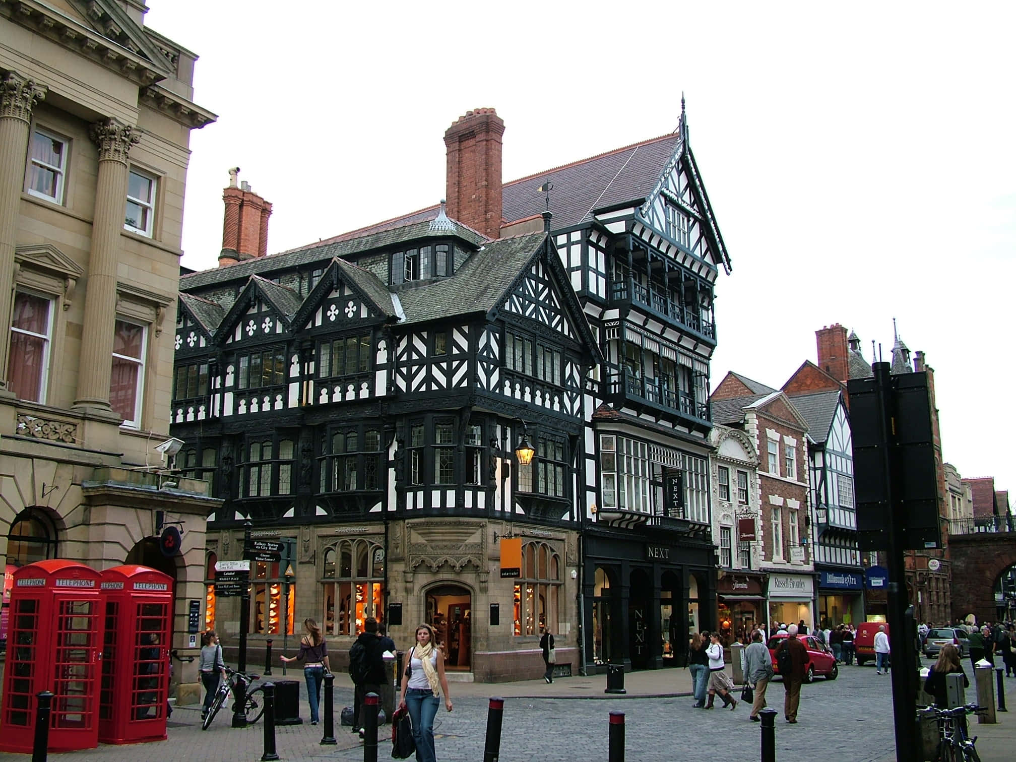 Chester, black and white timber-framed building, bustling city street corner, Full HD Desktop Wallpaper