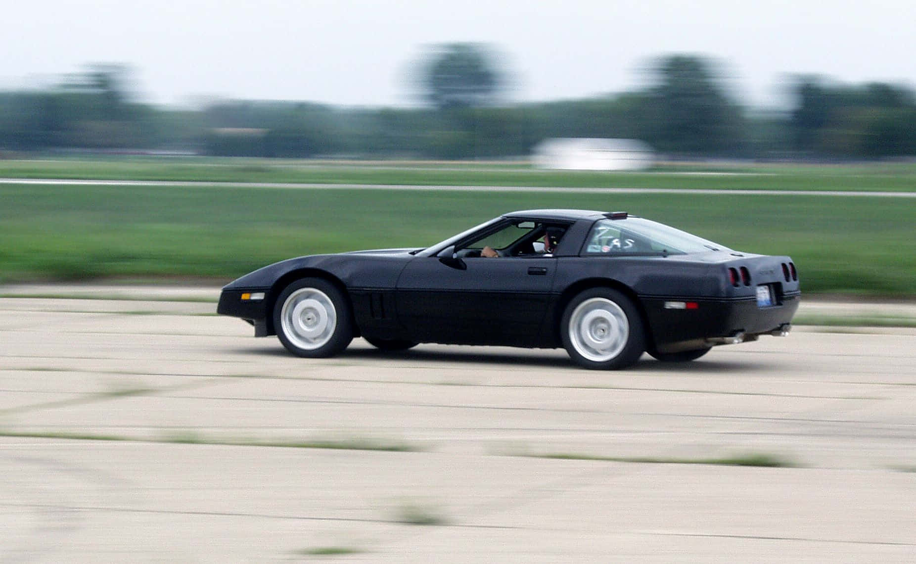 Chevrolet Corvette C4, sleek black sports car, paved track, HD Desktop Wallpaper