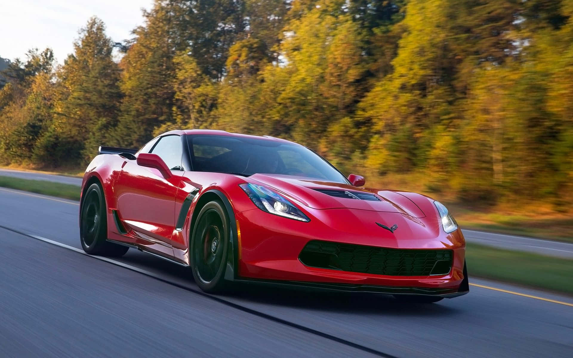 Chevrolet Corvette Z06, vibrant red, forest-lined road, Full HD Desktop Wallpaper
