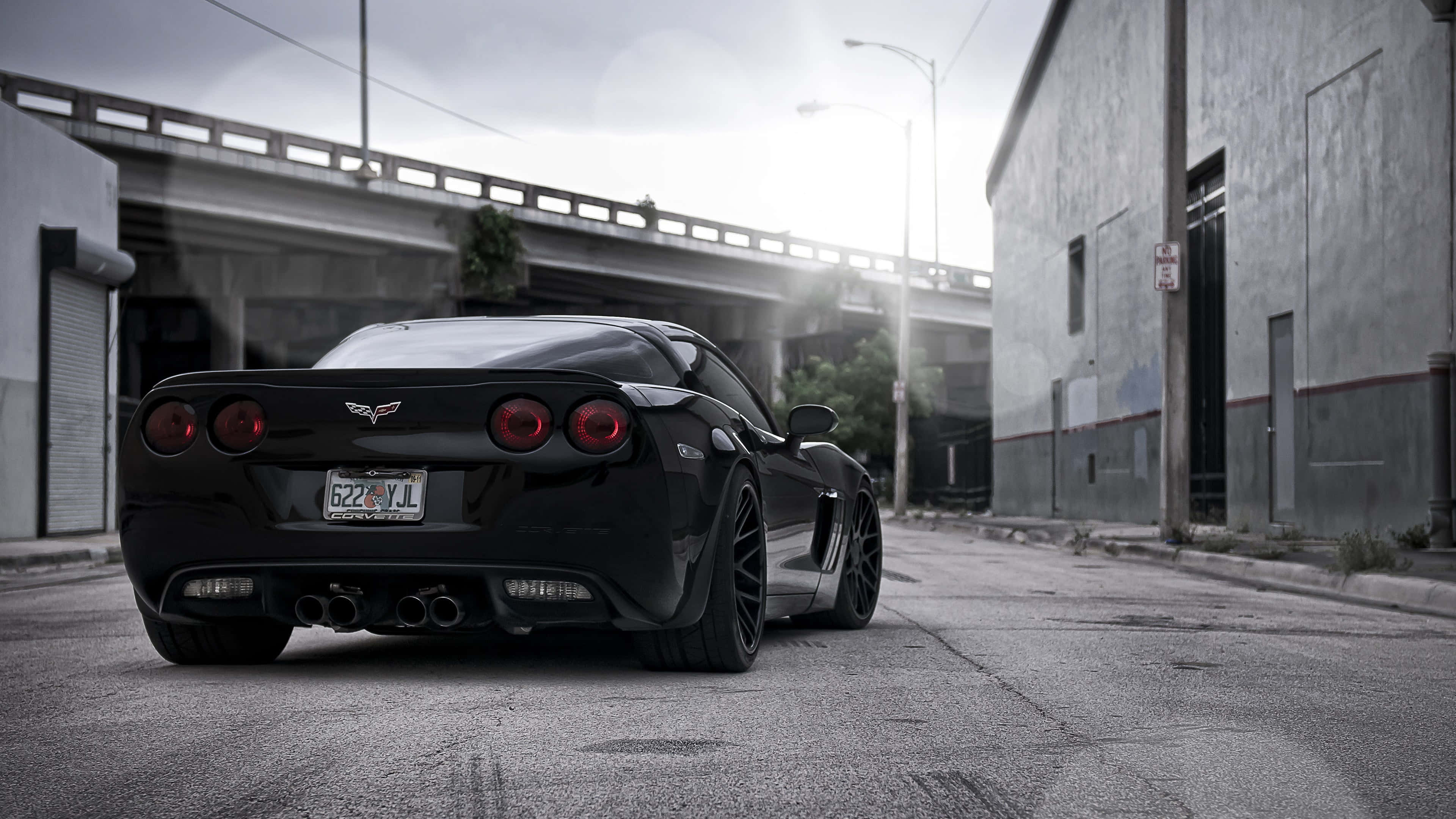 Chevrolet Corvette ZR1, sleek black sports car, glowing red taillights, 4K Desktop Wallpaper