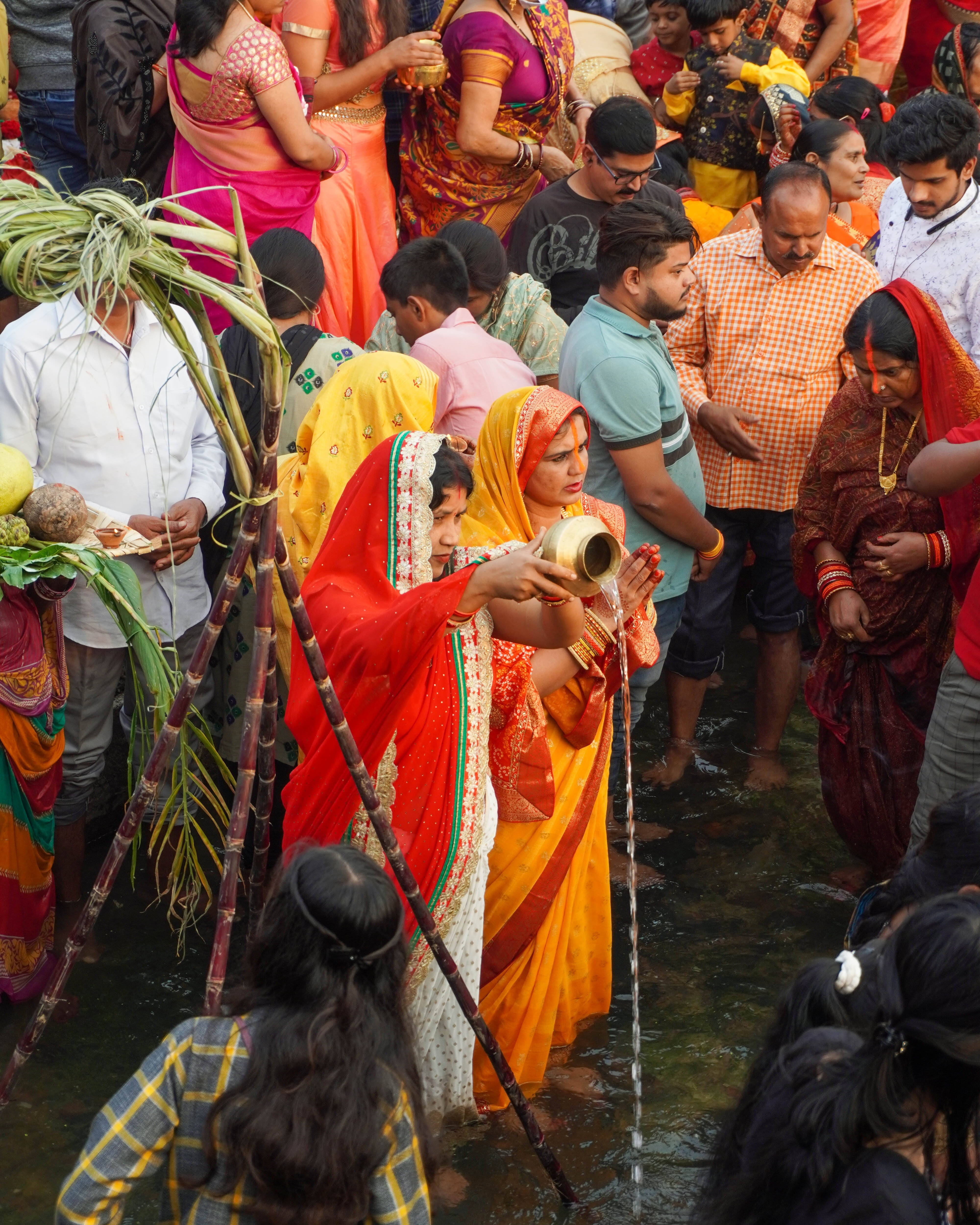 Chhath Puja, vibrant orange and red sari, brass pot, 4K Phone Wallpaper