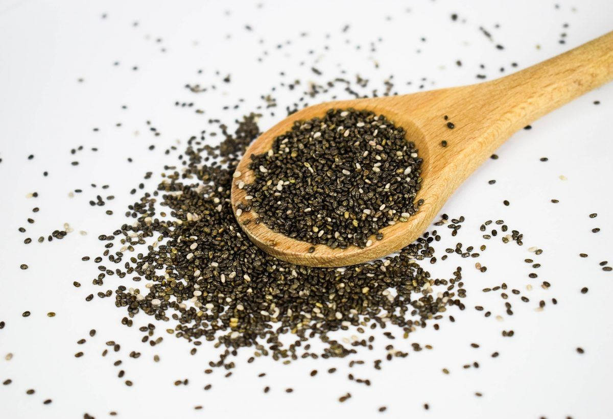 wooden spoon, black and white chia seeds, clean white surface, SD Desktop Wallpaper
