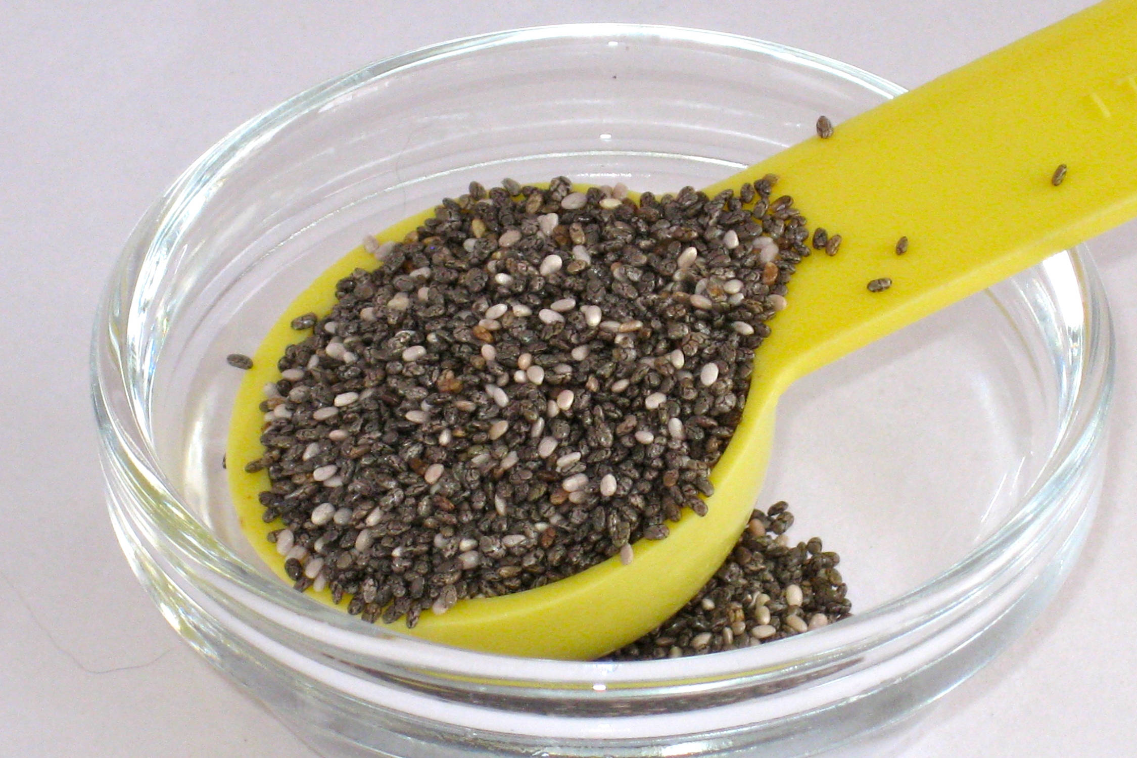 black and white chia seeds, bright yellow spoon, clear glass bowl, Full HD Desktop Wallpaper