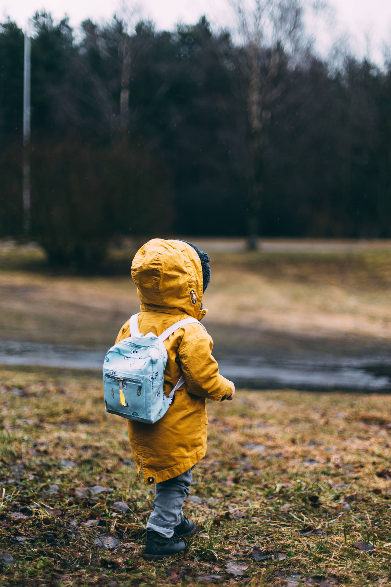 yellow raincoat, light blue backpack, damp grassy field, Full HD Phone Wallpaper