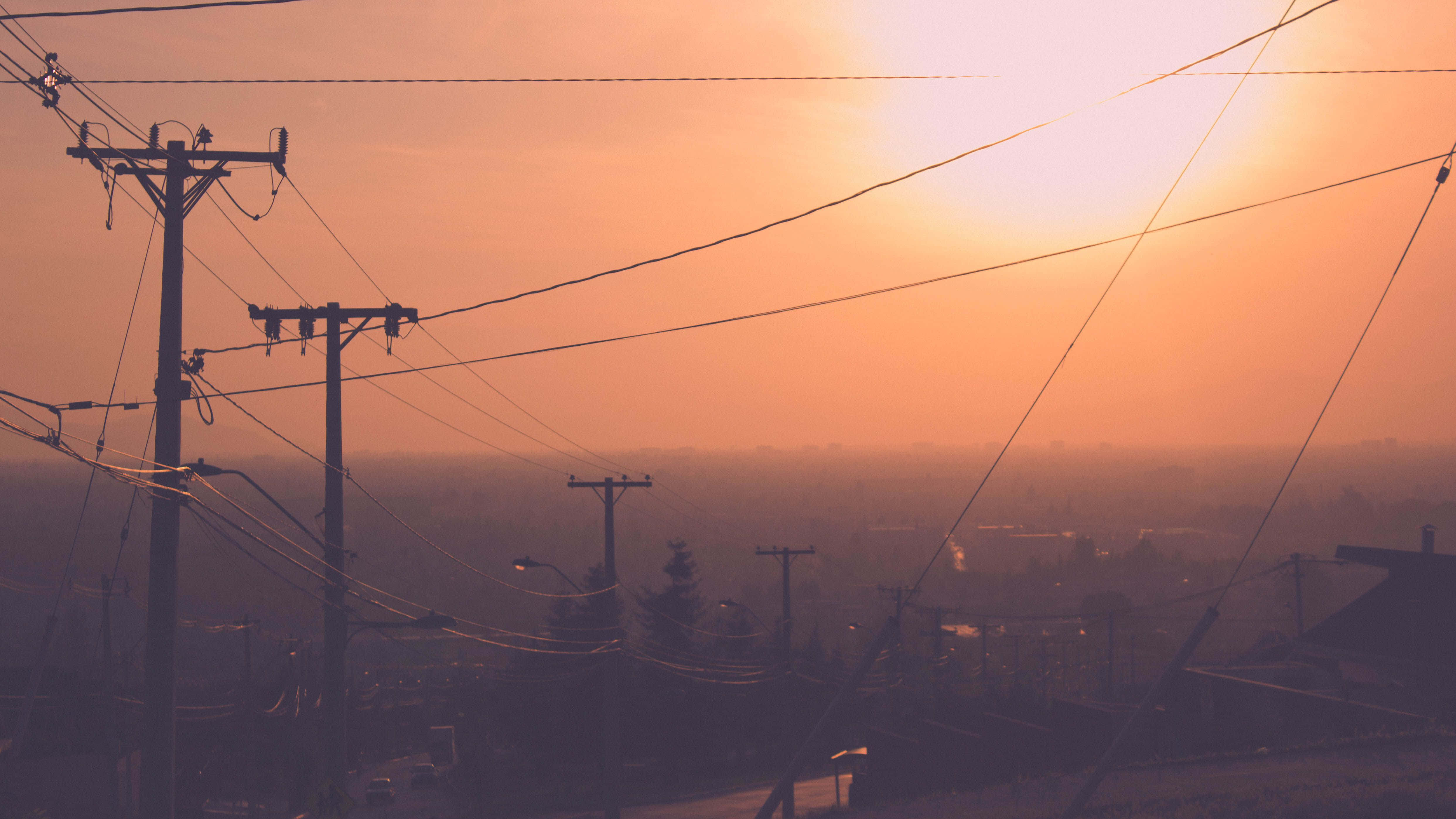power lines, hazy orange sky, distant urban landscape, 4K Desktop Wallpaper