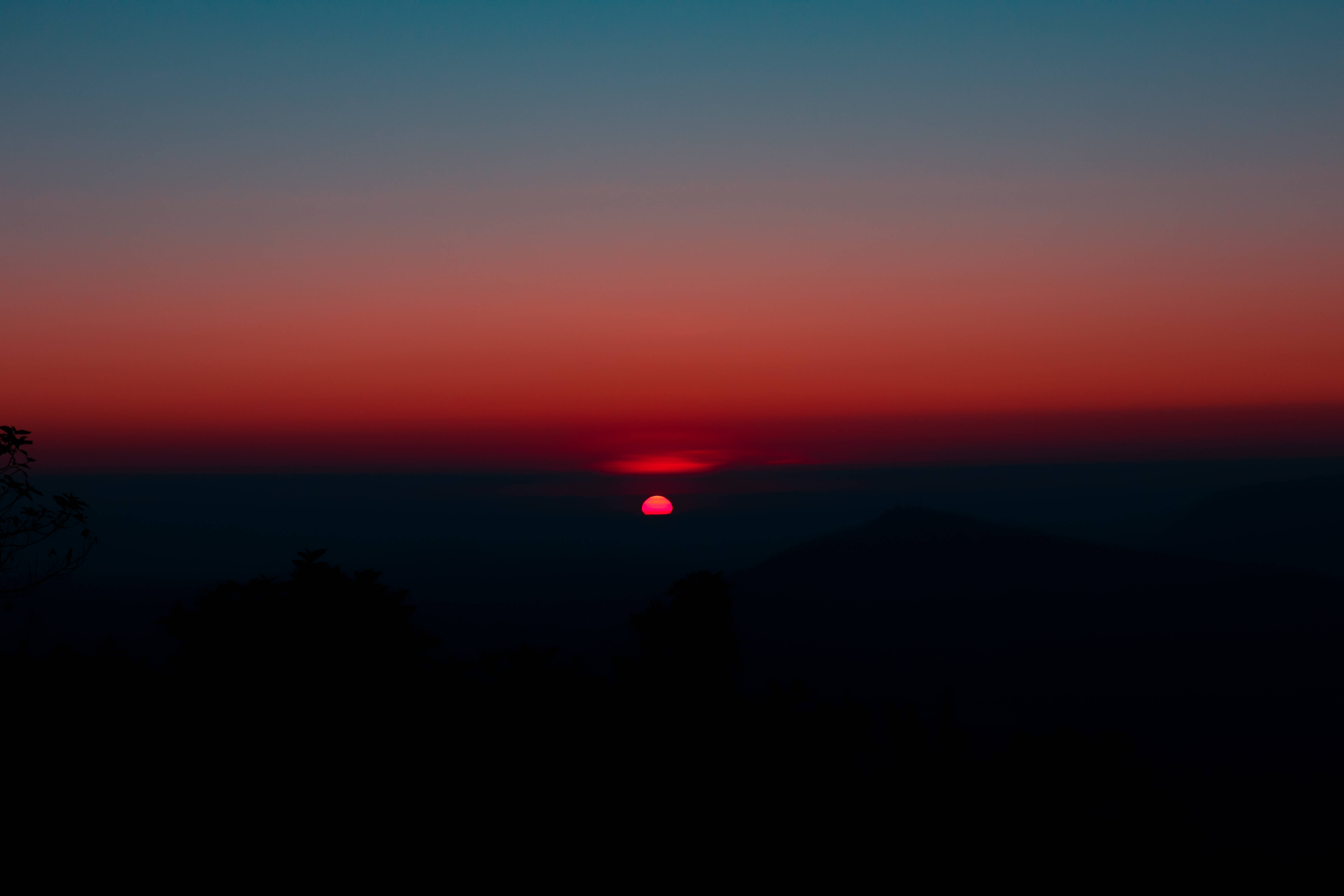 mountain silhouette, sunset, vibrant red sun, 5K Desktop Wallpaper