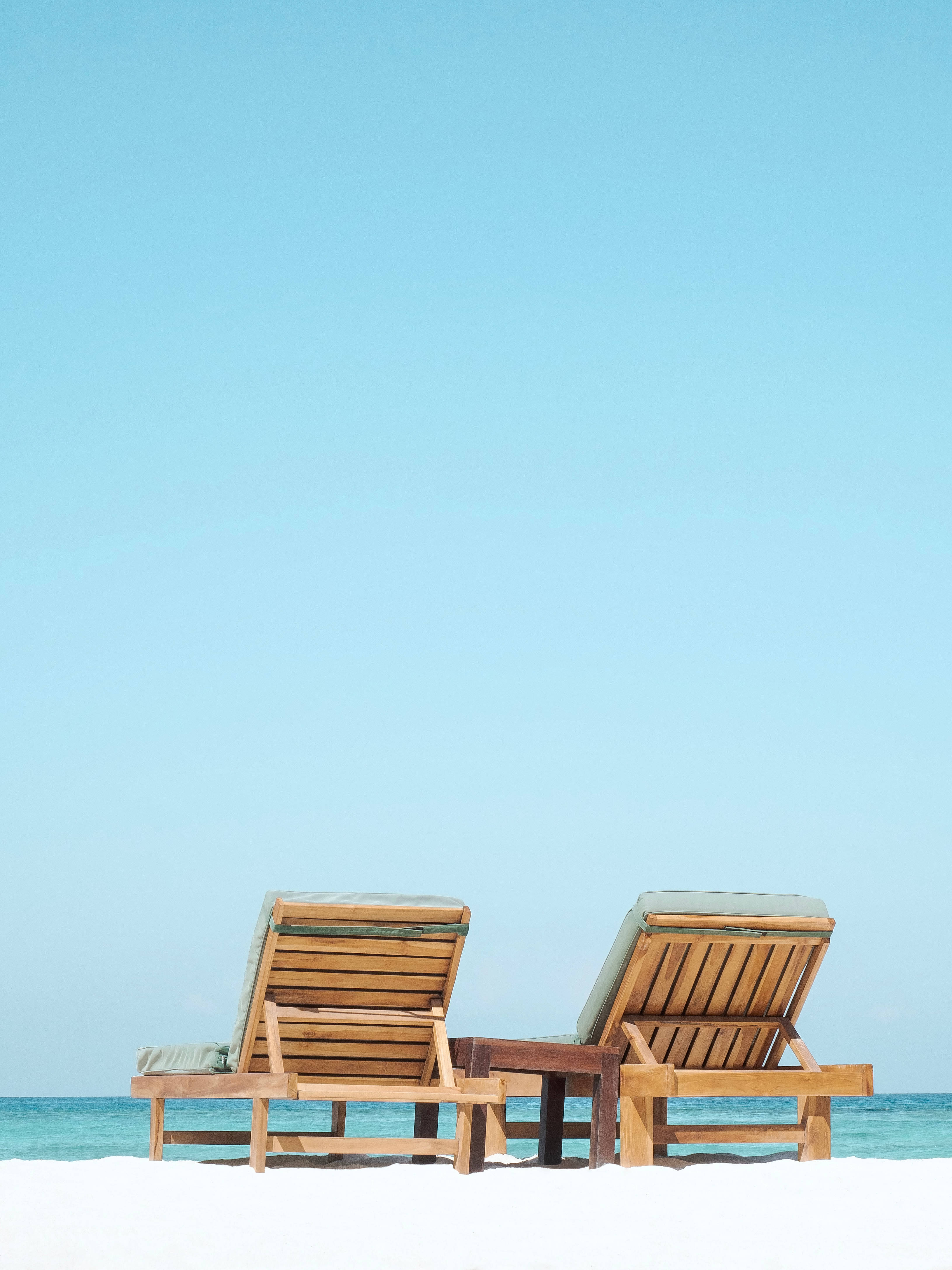 wooden beach loungers, turquoise ocean, clear blue sky, 4K Phone Wallpaper