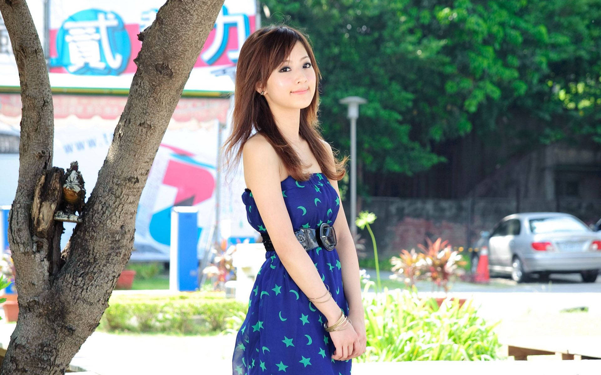 Chinese Girl, blue star-patterned dress, sunlit urban park, Full HD Desktop Wallpaper