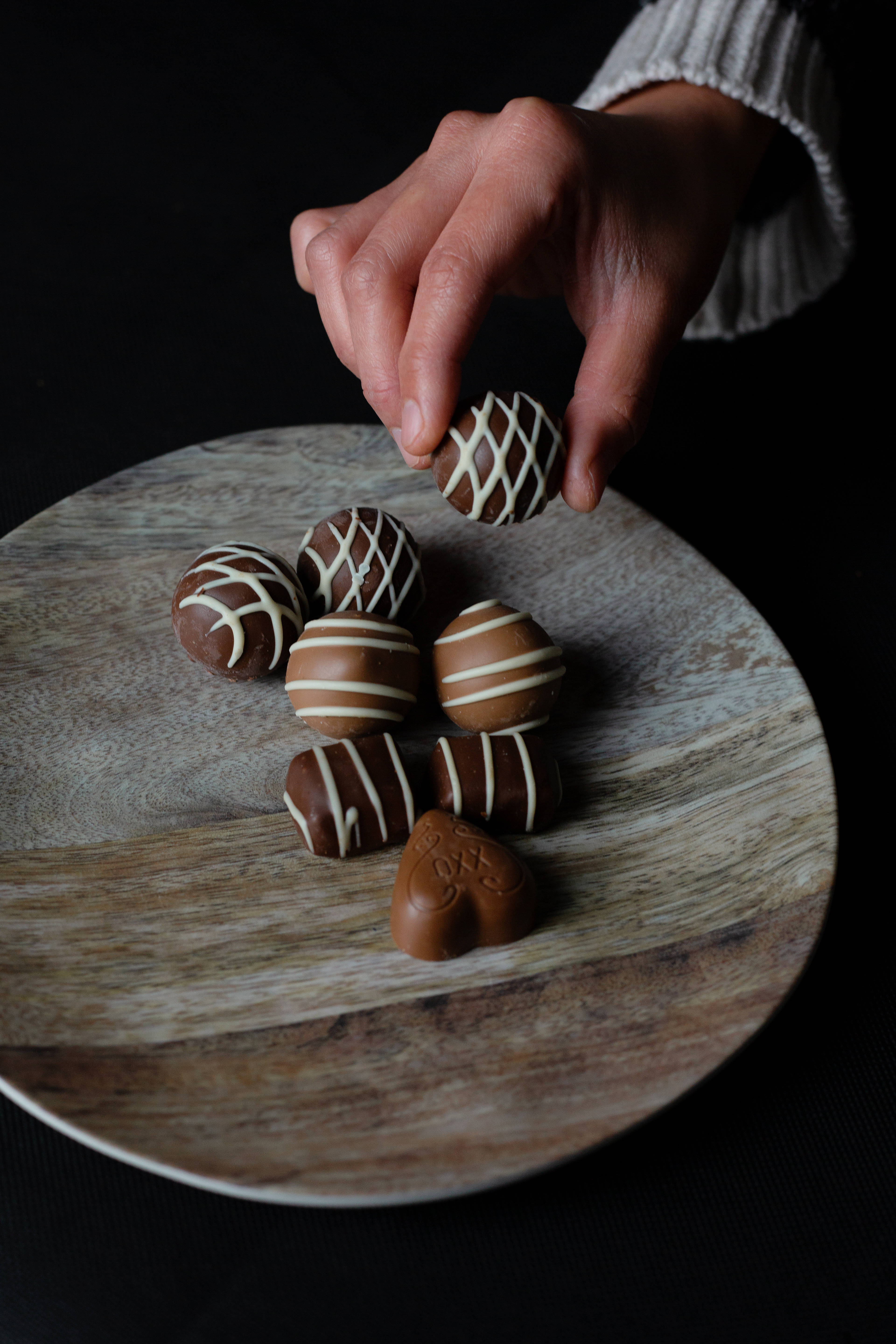chocolate truffles, white-striped chocolate truffle, rustic wooden plate, 5K Phone Wallpaper