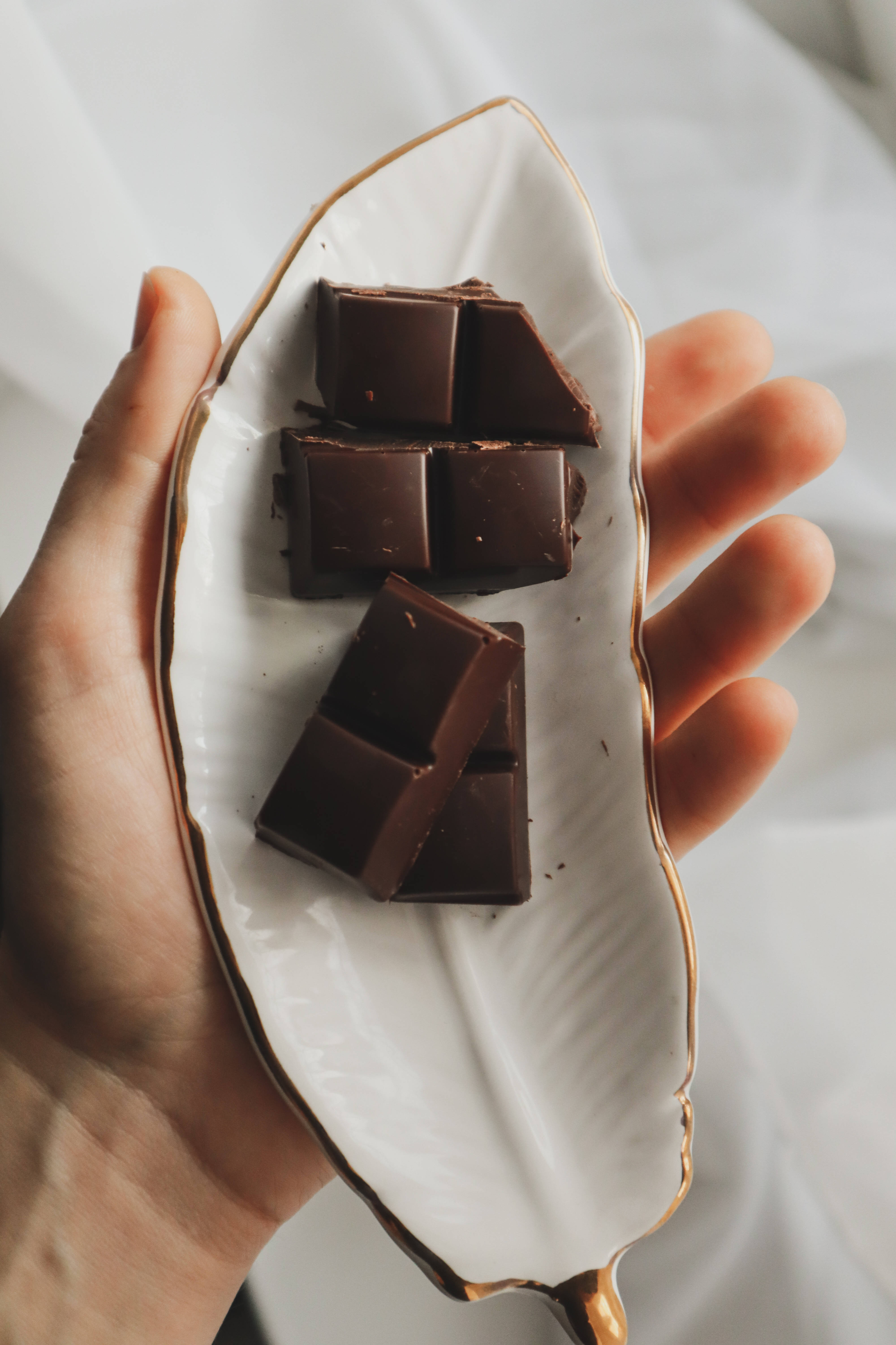 white plate, gold trim, dark chocolate squares, 5K Phone Wallpaper