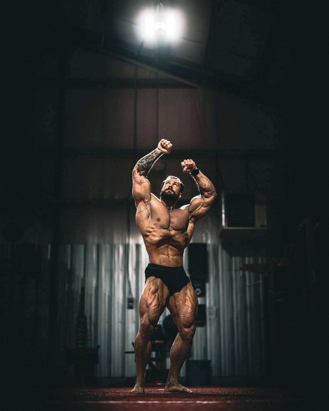 Chris Bumstead, vacuum bodybuilding pose, bright spotlight, HD Phone Wallpaper