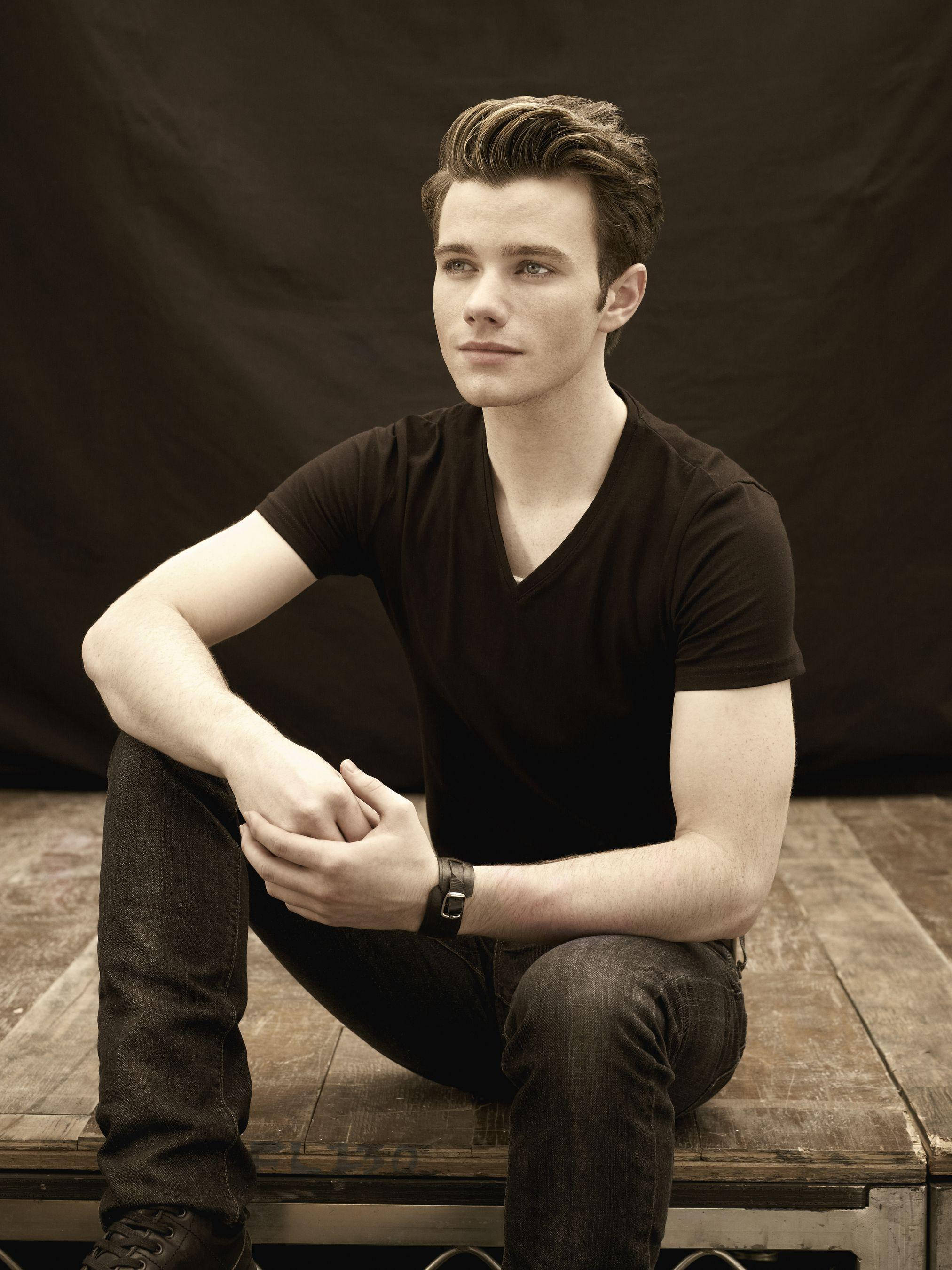 Chris Colfer, wooden bench, dark backdrop, 2K Phone Wallpaper