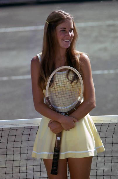 Chris Evert, yellow tennis dress, sunlit court, SD Phone Wallpaper