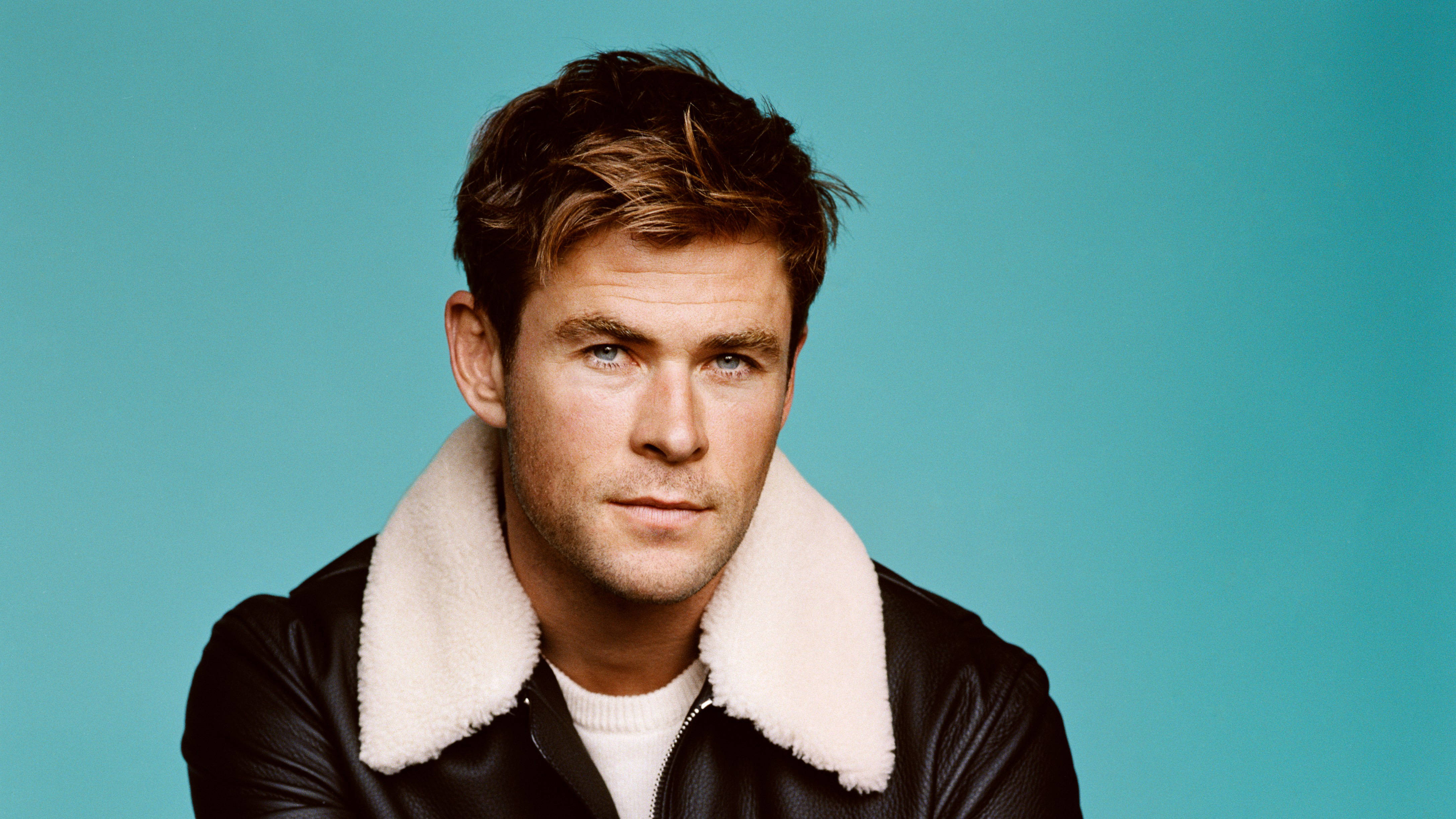 Chris Hemsworth, black shearling collar jacket, teal background, 4K Desktop Wallpaper