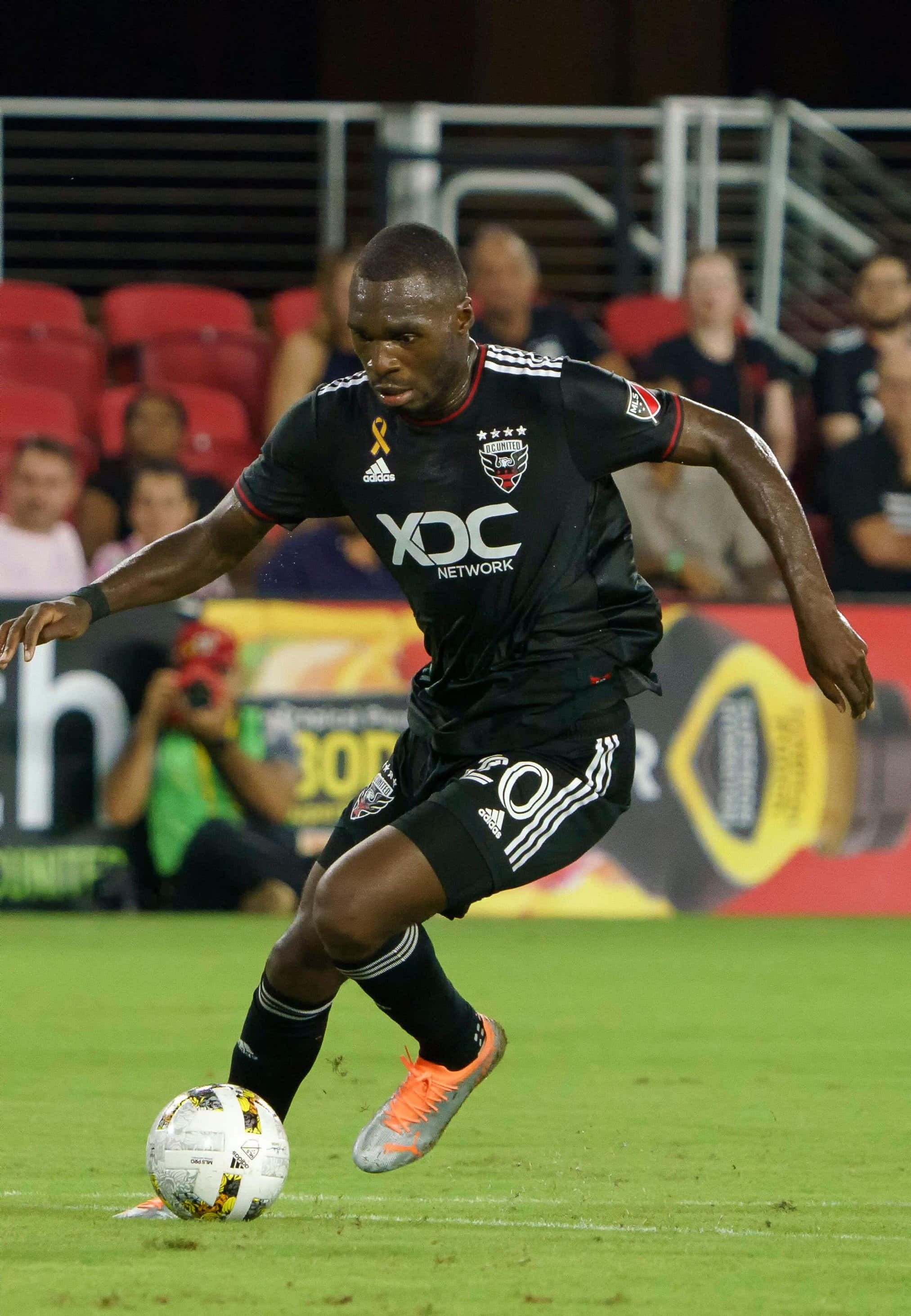Christian Benteke, black uniform, green field, 2K Phone Wallpaper
