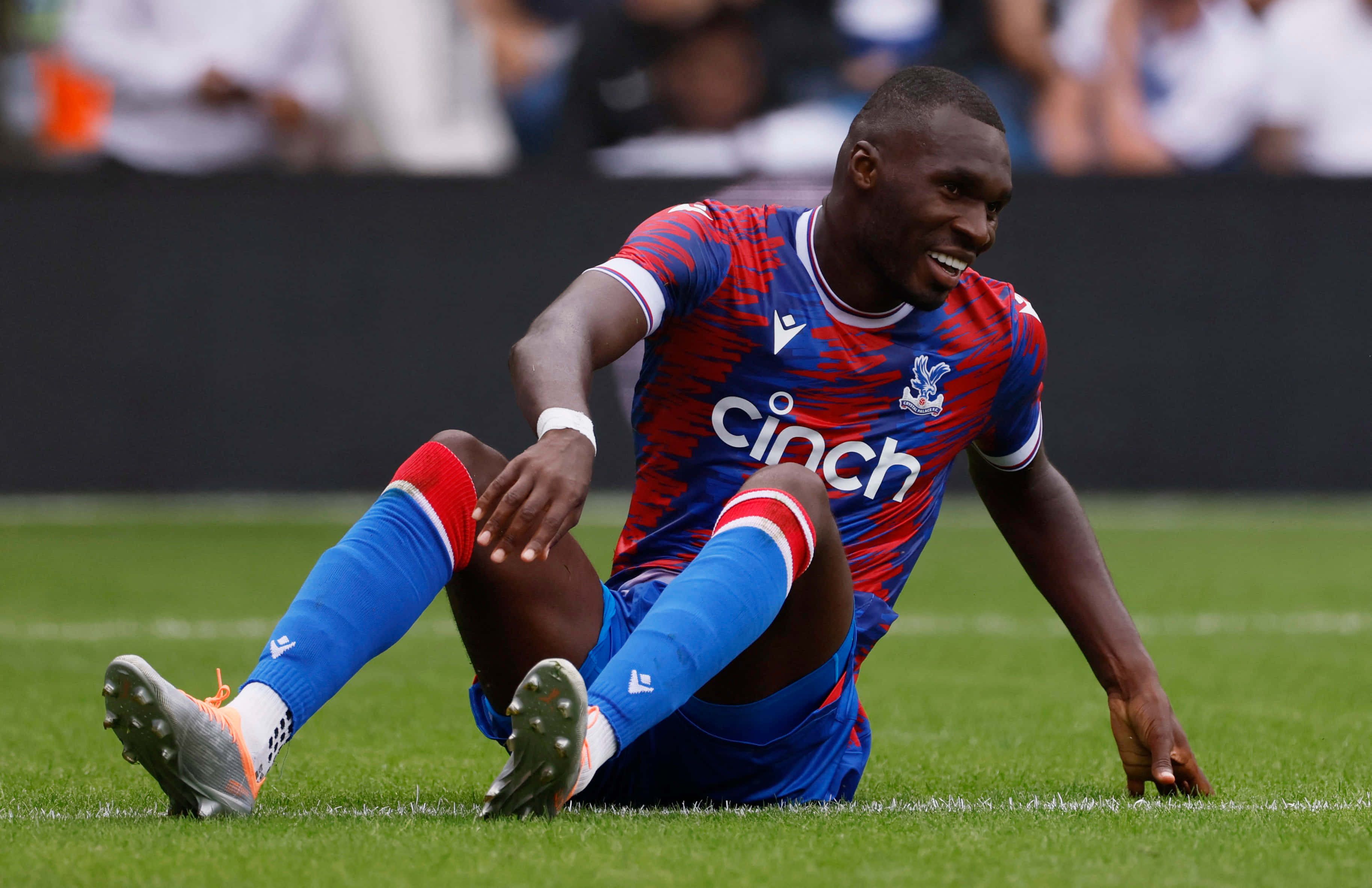 Christian Benteke, red and blue striped jersey, vibrant green grass, 2K Desktop Wallpaper