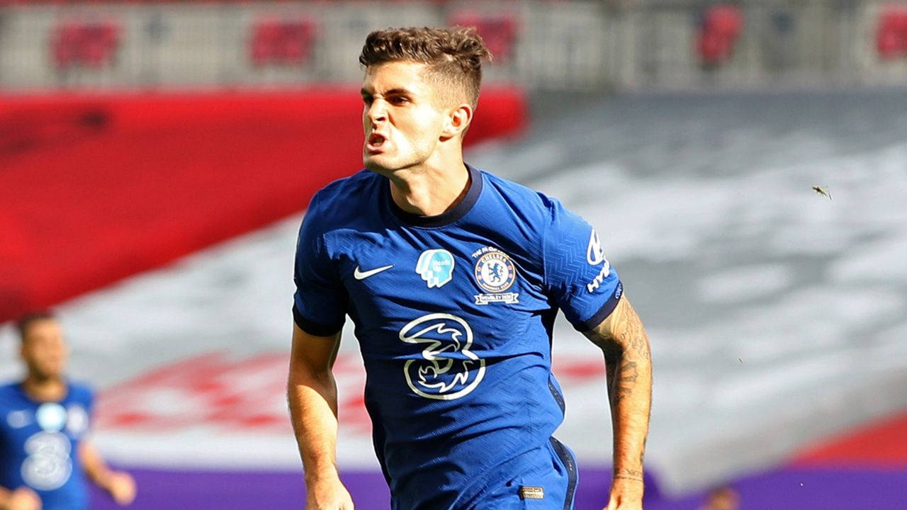 Christian Pulisic, blue Chelsea jersey, sunlit stadium field, HD Desktop Wallpaper