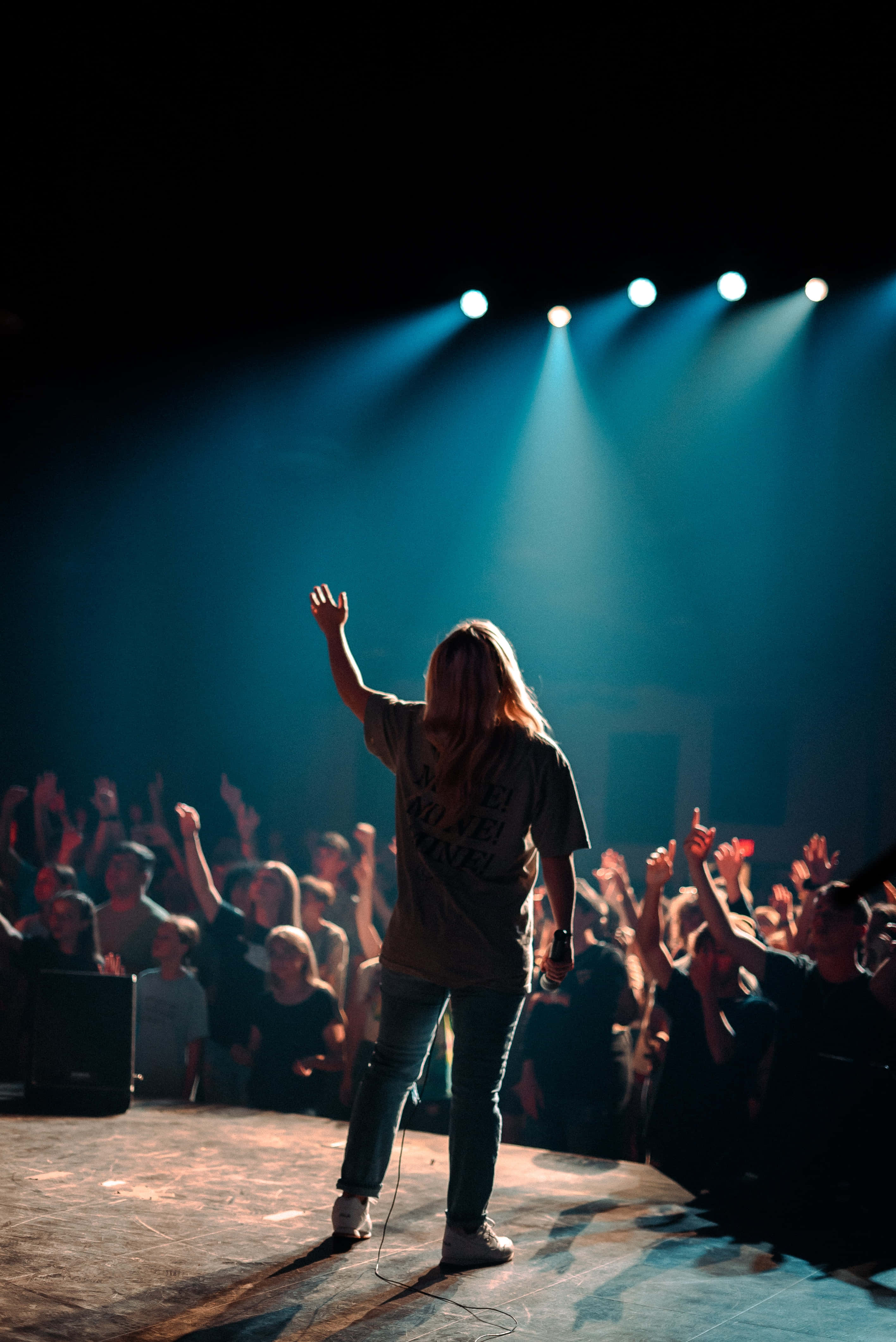 worship leader, dimly lit stage, blue spotlights, 4K Phone Wallpaper