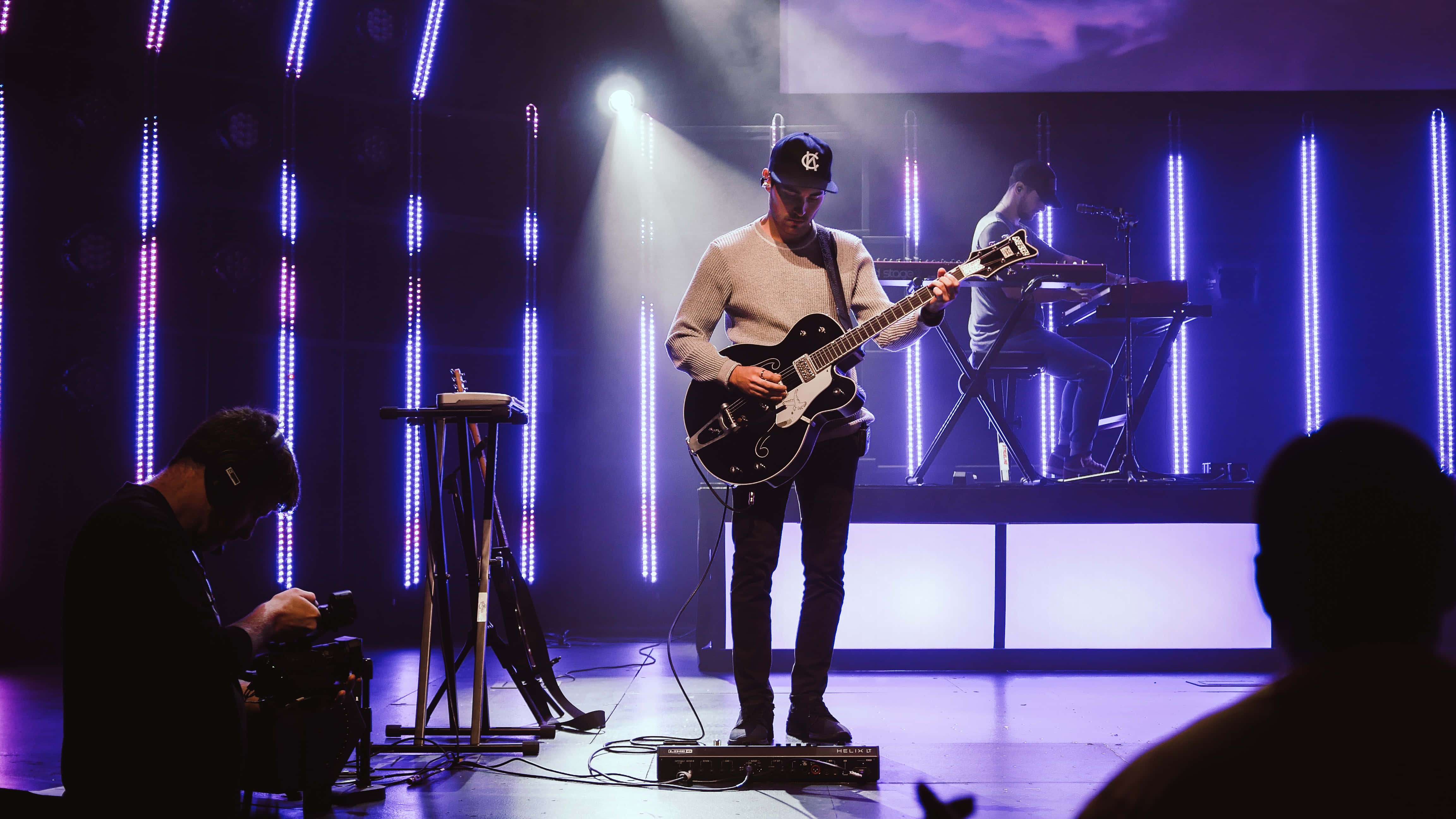 Worship Leader, electric guitar, vibrant blue lit stage, 4K Desktop Wallpaper