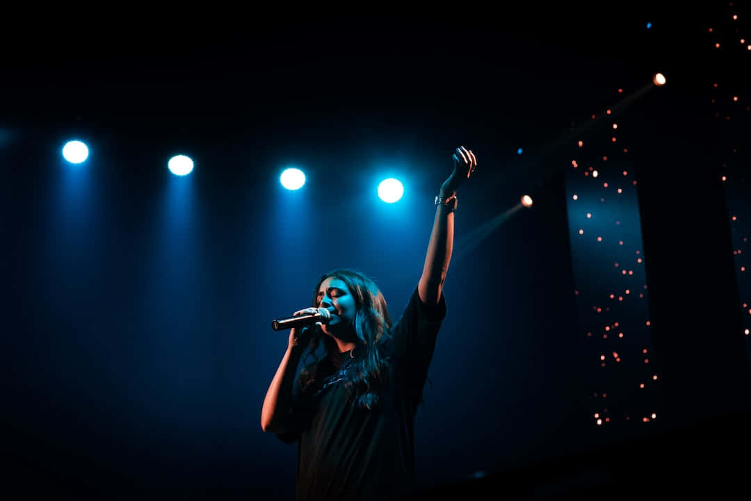 Worship Leader, blue stage lights, dark concert venue, SD Desktop Wallpaper