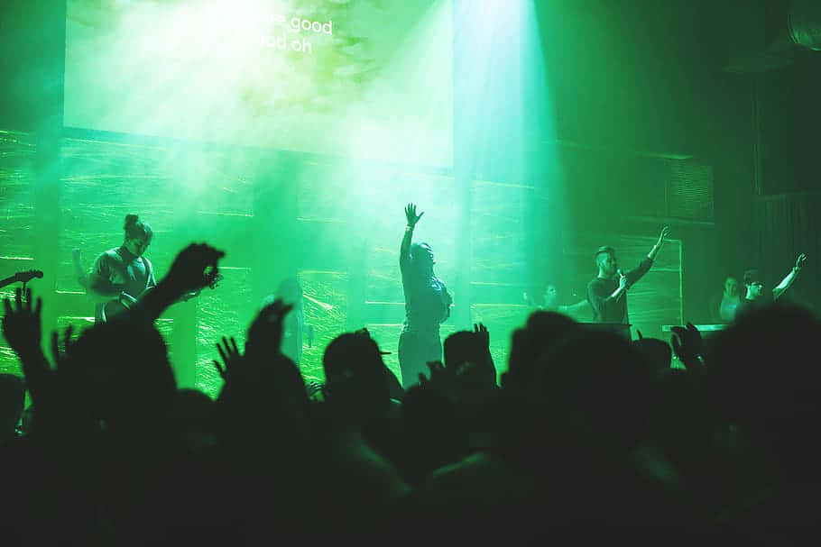 vibrant green stage lights, hazy illuminated stage, silhouetted concert crowd, SD Desktop Wallpaper