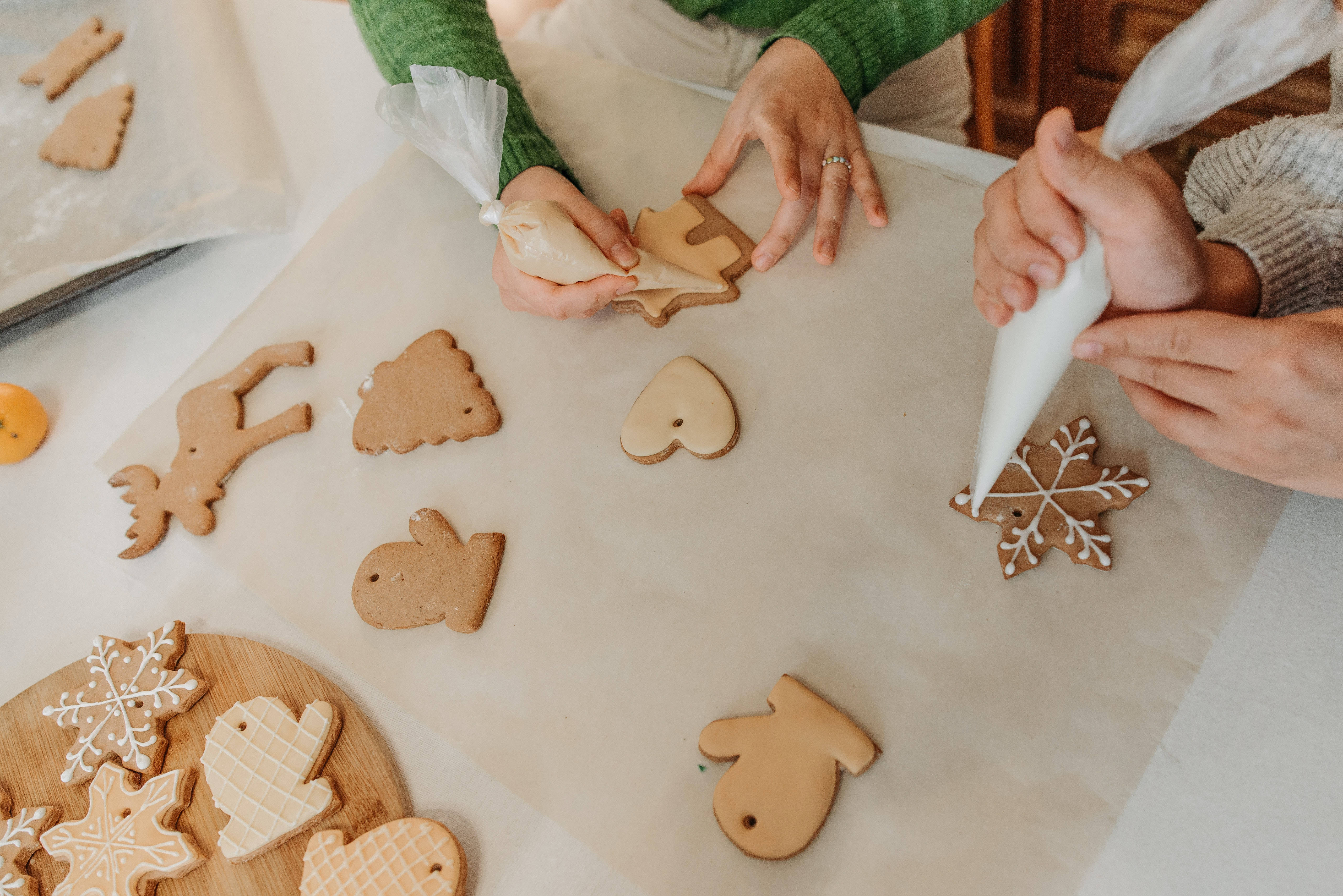 gingerbread cookies, white icing, parchment-lined table, 5K Desktop Wallpaper